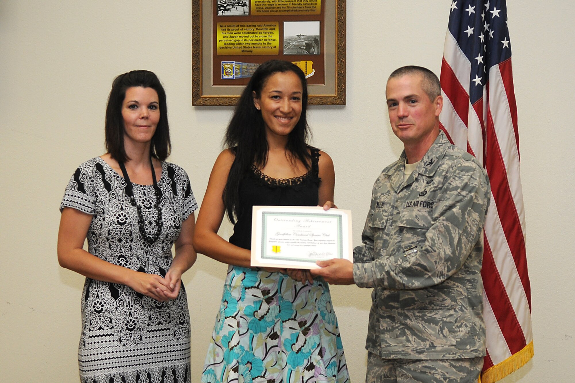 (Right to left) Col. JD Willis, 17th Training Group Commander presents Chantelle Girley, Goodfellow Combined Spouses Club president and Emily Swinarski, the club’s secretary an Outstanding Achievement Award certificate in recognition and gratitude for their service. (U.S. Air Force photo/Senior Airman Heather Rodgers)

