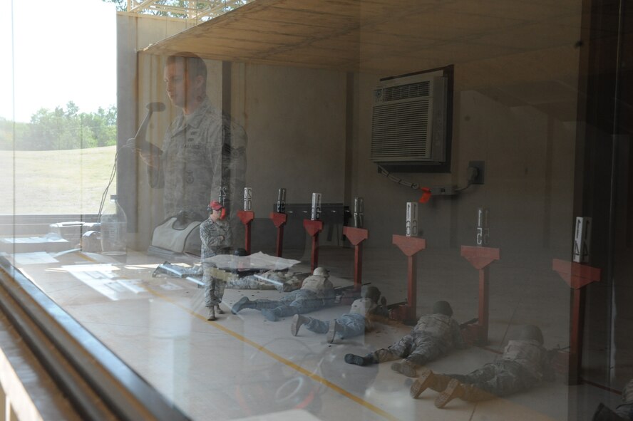 Senior Airman Nicholas Niles, Combat Arms Training and Maintenance instructor, gives Airmen instructions at the firing range on Barksdale Air Force Base, La., Aug 18. The Airmen donned interceptor ballistics armor and helmets to acclimate them with aiming and firing the M-16A2 rifle in full battle rattle.(U.S. Air Force photo/Airman 1st Class Micaiah Anthony)(RELEASED)