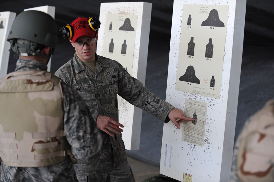 Senior Airman James Robinette, Combat Arms Training and Maintenance instructor, gives firing advice to an Airman in the CATM course on Barksdale Air Force Base, La., Aug. 18.  The Airmen in the course fired the M-16A2 rifle which is an air-cooled, gas-operated, magazine-fed, assault rifle with a muzzle velocity of 3,110 feet per second. (U.S. Air Force photo/Airman 1st Class Micaiah Anthony)(RELEASED)