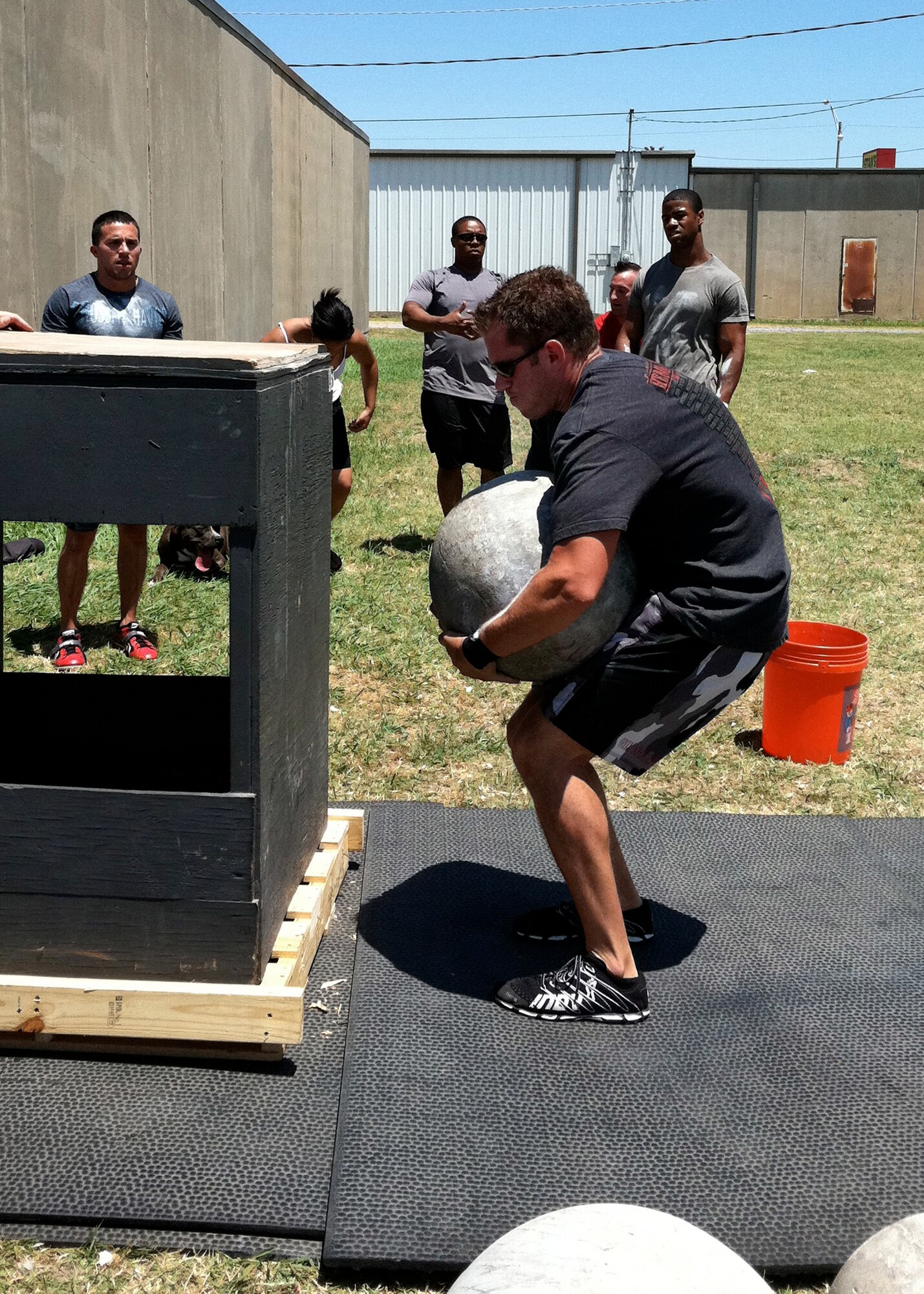 ALTUS AIR FORCE BASE, Okla. -- Air Force Capt. Chris Pace, 58th Airlift Squadron instructor pilot, lifts a concrete atlas stone onto a pedestal during a strongman competition at CrossFit Havoc in Lawton, Okla. June 25, 2011. Pace is planning to bike from Arlington National Cemetery, Va., for approximately 150 miles and then run another 100 miles to Ground Zero in New York City, N.Y., Sept. 10-11 without stopping to rest. Pace is calling his athletic quest the “Journey of Freedom” and he is doing it in support of The Disposable Heroes Project, which is a non-profit organization that supports wounded and fallen warriors and their families. (Courtesy photo)