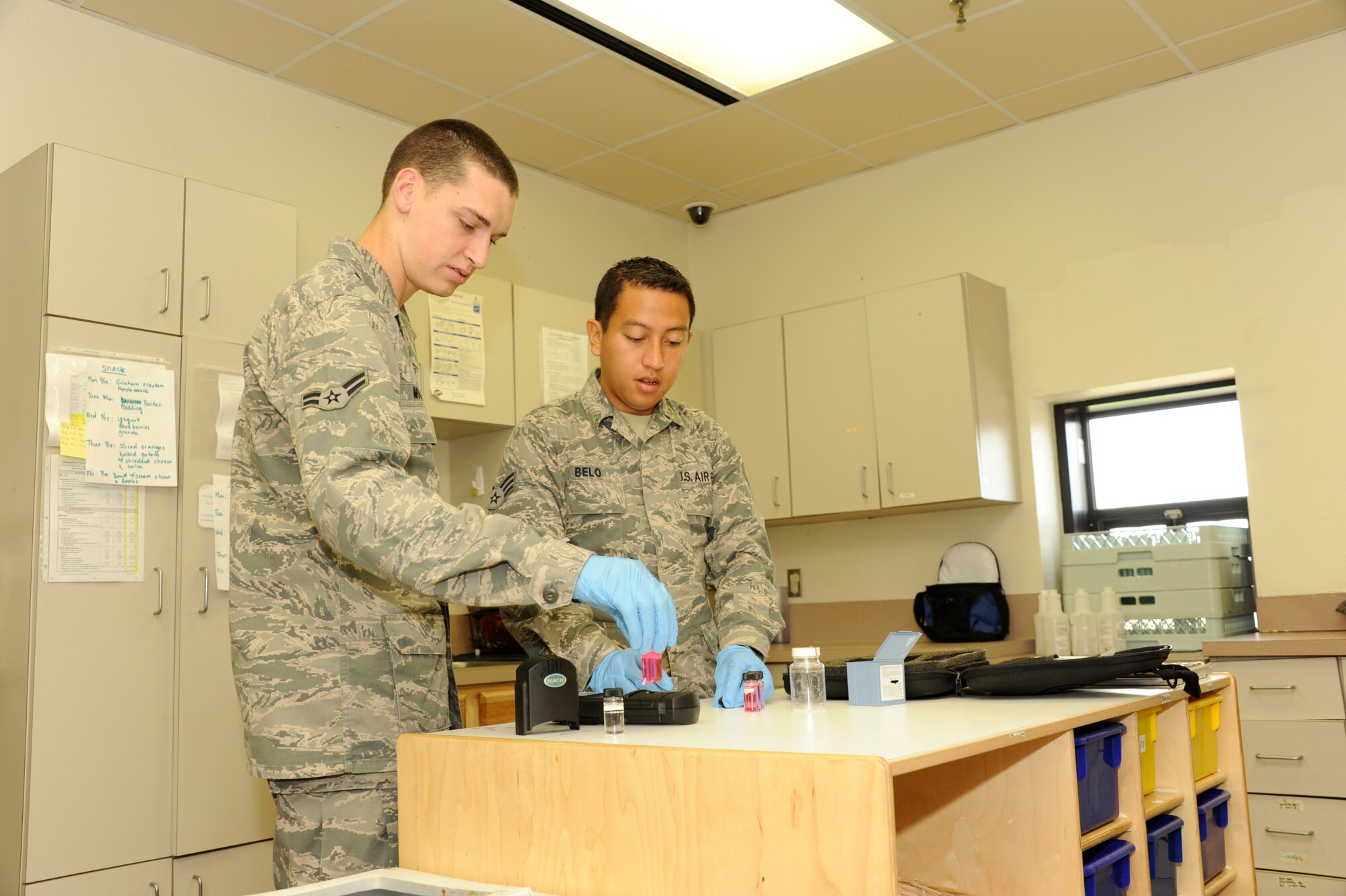 Senior Airman Christian Belo and Airman 1st Class Casey Mowatt test the water at the Madrigal Youth Center, Sheppard Air Force Base Aug. 16. The Sheppard AFB Bioenvironmental Engineering Office continues to monitor the base’s water to ensure safety for drinking. (U.S. Air Force Photo/Danny Webb)
