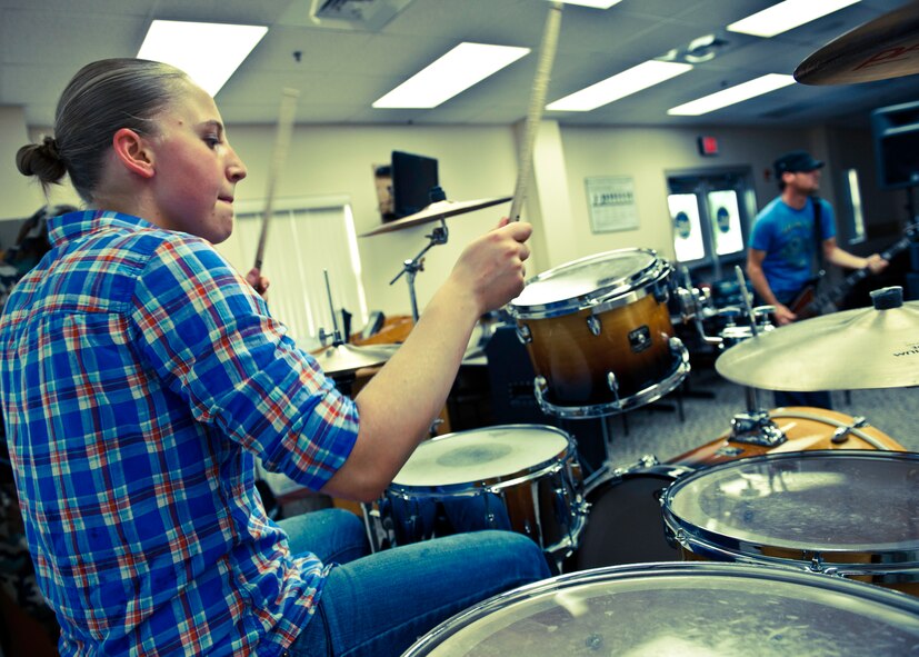 Senior Airmen Brittany Caruso and Shane Goss rock out during a Sonic Cell practice session on Eglin Air Force Base, Fla.  The four-person alternative rock band is made up of enlisted Airmen from the 96th Air Base Wing.  (U.S. Air Force photo/Samuel King Jr.)