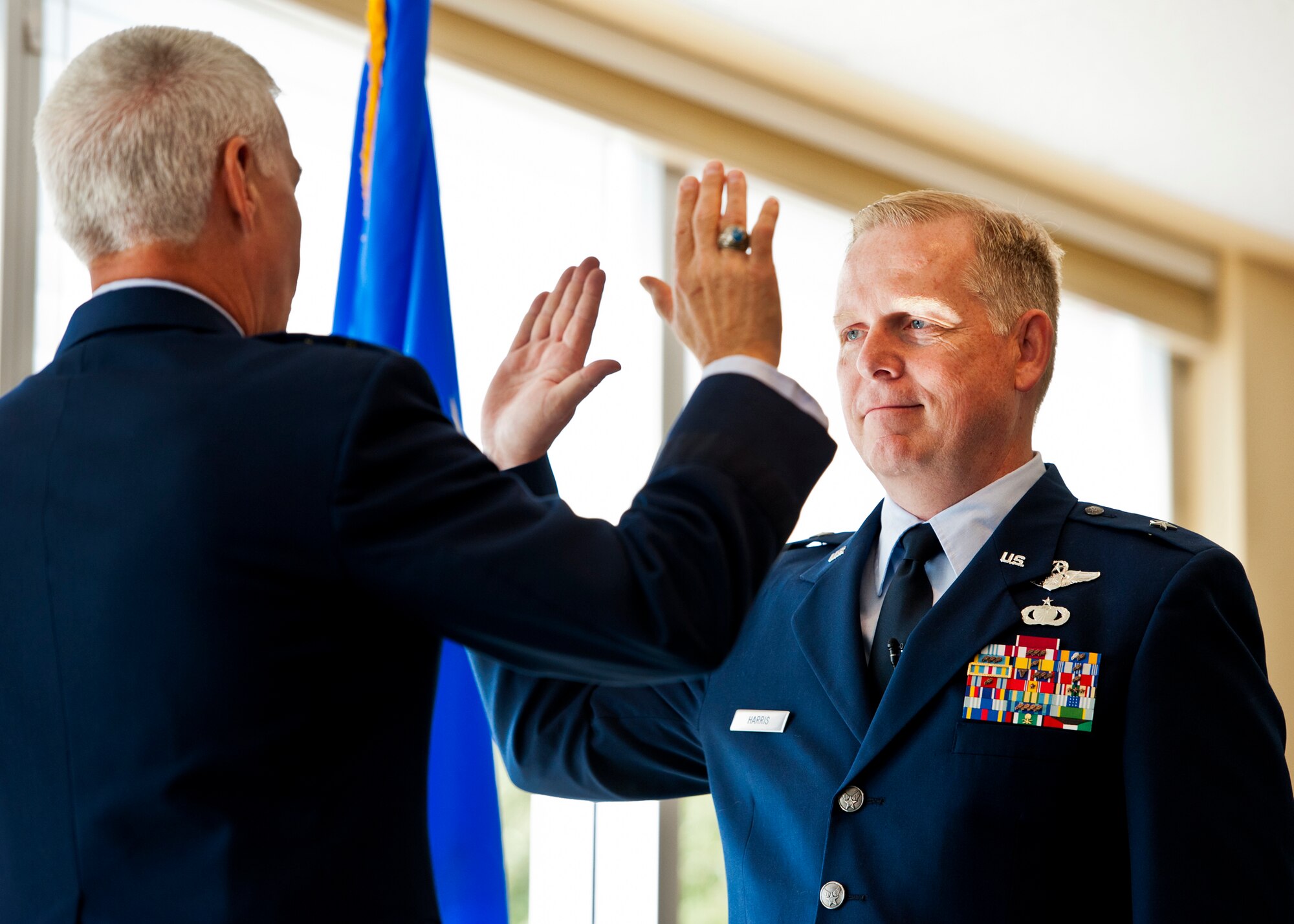 Newly-ranked Brig. Gen. David Harris, Air Armament Center vice commander, receives the oath of office from Maj. Gen. C.R. Davis, the AAC commander, during his one-star pin-on ceremony Aug. 19 at Eglin Air Force Base, Fla.  (U.S. Air Force photo/Samuel King Jr.)