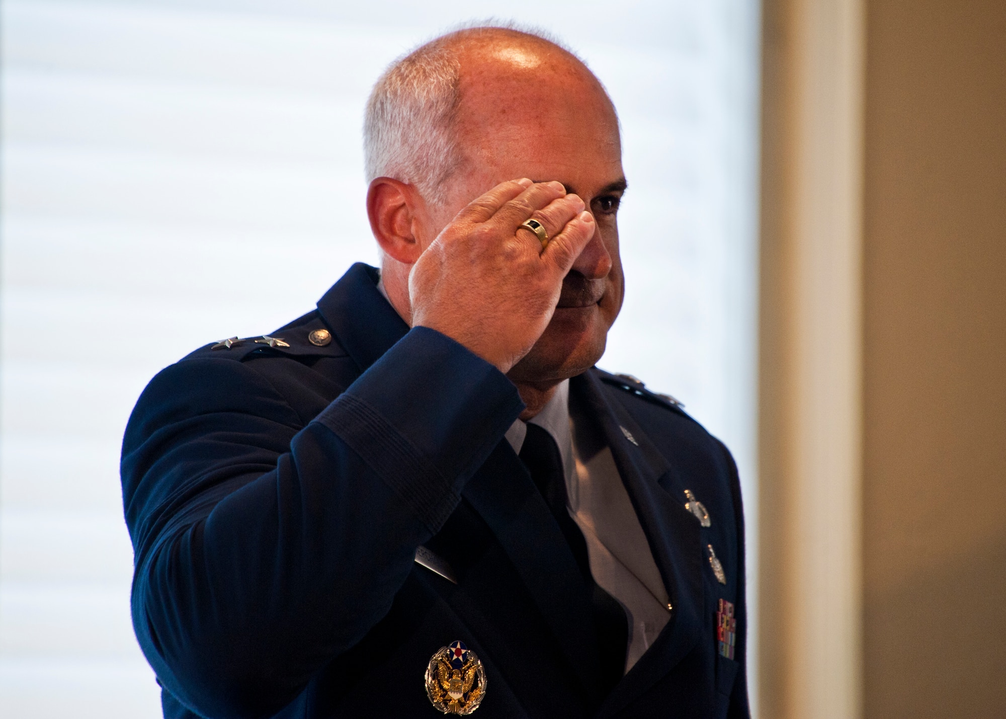 Maj. Gen. Kenneth Merchant salutes his wings for the first time as commander of the Air Armament Center during his change of command ceremony at Eglin Air Force Base, Fla., Aug. 19.  Merchant took command of the center from Maj. Gen. Charles R. Davis.  (U.S. Air Force photo/Samuel King Jr.)