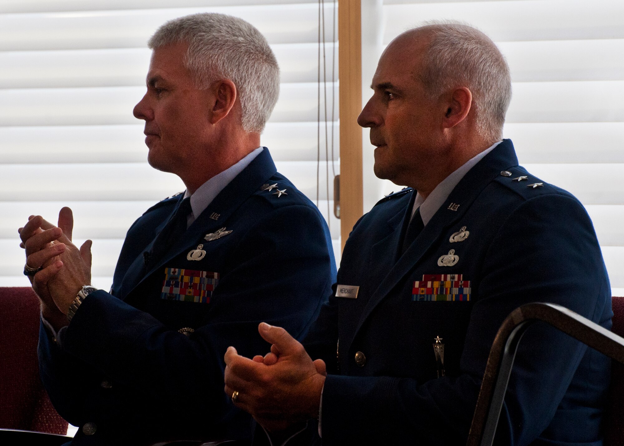 Outgoing commander, Maj. Gen. Charles R. Davis and incoming commander, Maj. Gen. Kenneth Merchant, sit together during the Air Armament Center change of command ceremony at Eglin Air Force Base, Fla., Aug. 19. (U.S. Air Force photo/Samuel King Jr.)