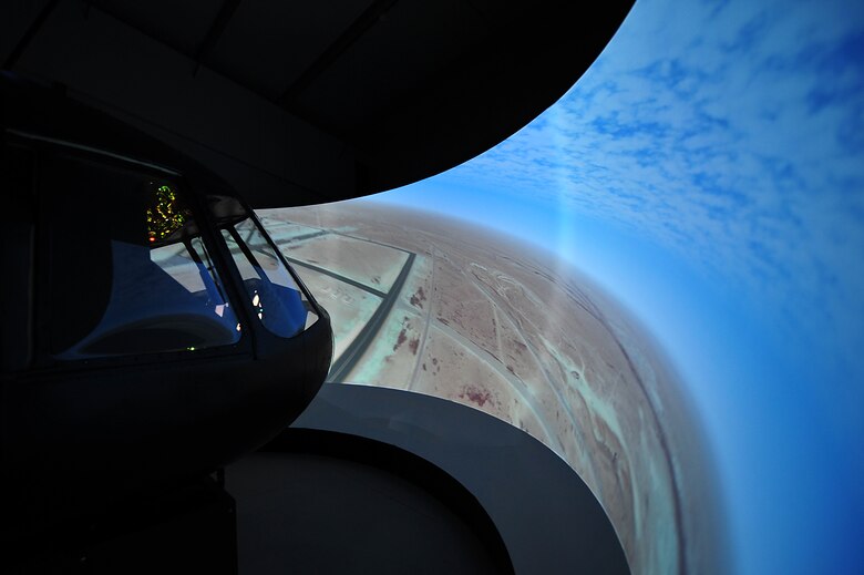 The MI-171 helicopter simulator screen warps around the cockpit nose, providing a 180-degree view of simulated landscape for virtual flight operations at Taji Air Base, Iraq, Aug. 10, 2011. The new $4.8 million simulator provides invaluable training to Iraqi Army Aviation Command pilots, allowing them to experience multiple flight scenarios, including emergency conditions in a controlled, safe environment. (U.S. Air Force photo/Tech. Sgt. Josef Cole)