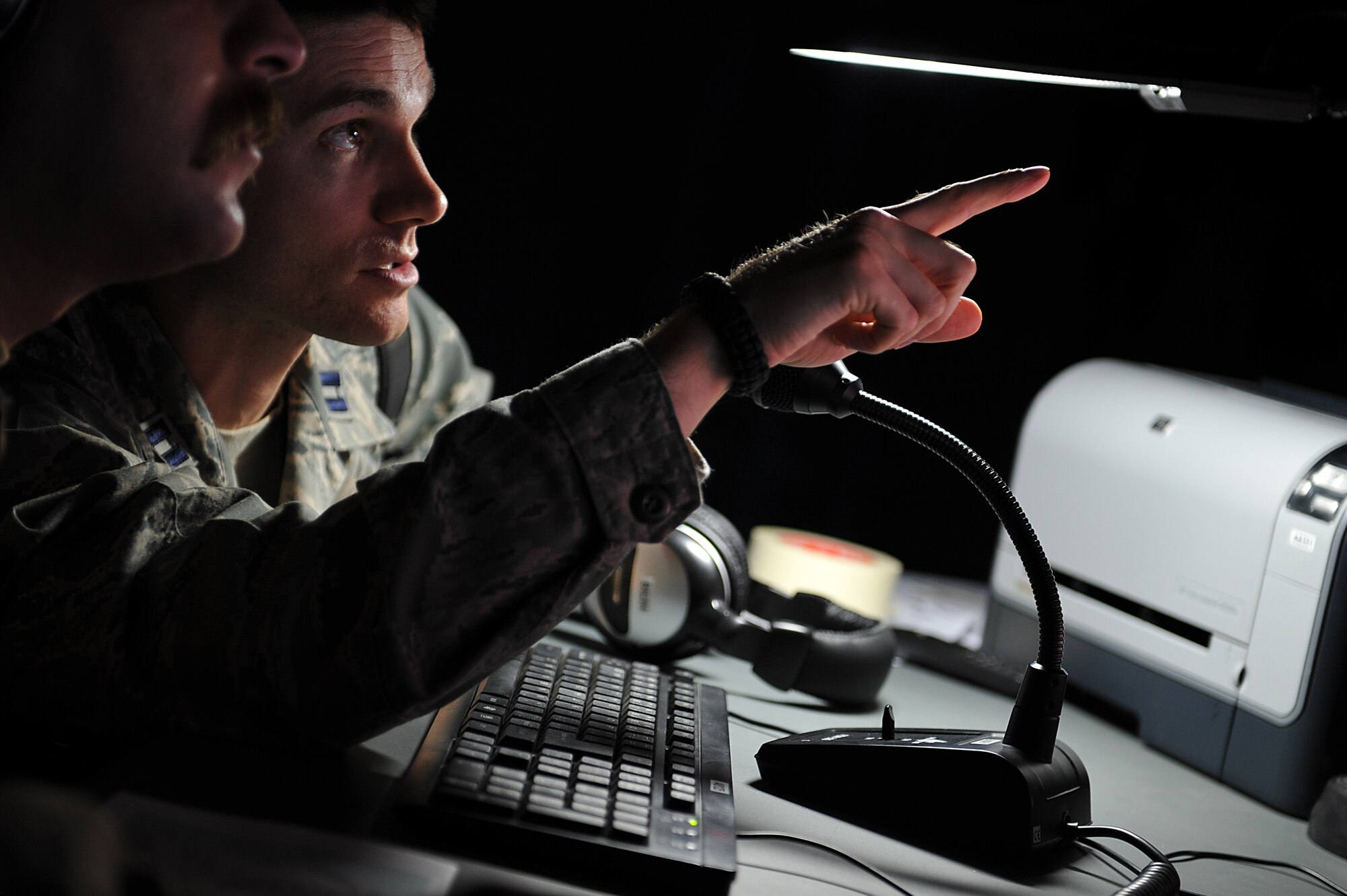 Capt. Zach Pellonari, 721st Air Expeditionary Advisory Squadron air advisor, trains with an Iraqi pilot on a MI-171 helicopter simulator at Taji Air Base, Iraq, Aug. 10, 2011. The new $4.8 million simulator provides invaluable training to Iraqi Army Aviation Command pilots, allowing them to experience multiple flight scenarios, including emergency conditions in a controlled, safe environment. (U.S. Air Force photo/Tech. Sgt. Josef Cole)