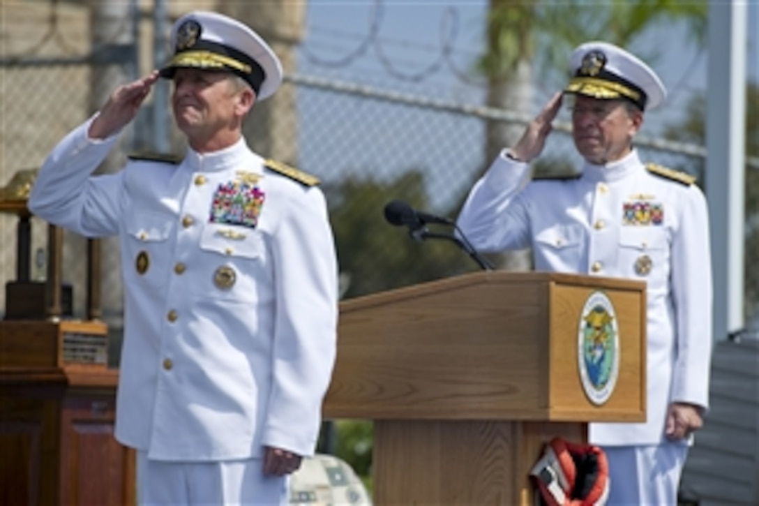 Navy Adm. Eric T. Olson and Navy Adm. Mike Mullen, chairman of the Joint Chiefs of Staff, salute as Olson's colors are hauled down at the conclusion of his retirement ceremony on Naval Amphibious Base Coronado, Calif., Aug. 22, 2011. Olson concluded a 38-year career as a U.S. Navy SEAL, serving at every operational level in the special warfare community and leading the community as commander of U.S. Special Operations Command. 