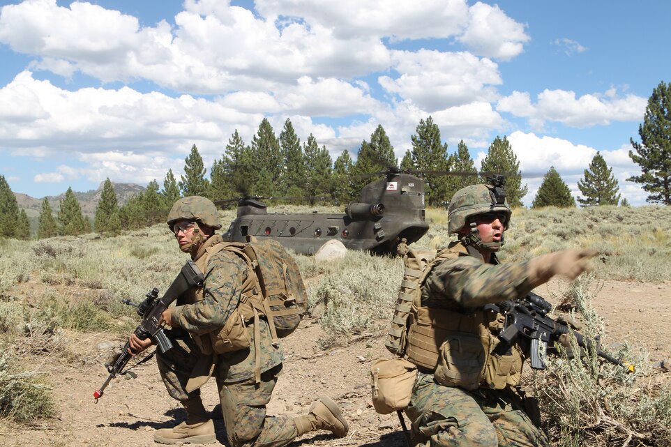 2nd Lt. George Russo, the executive officer for Headquarters and Service Company, 1st Battalion, 7th Marine Regiment, directs his Marines towards a CH-47 Chinook during a helicopter extraction in the heat of 1st Battalion, 7th Marine Regiment’s five day Final Exercise at the Marine Corps Mountain Warfare Training Center August 25, 2011.