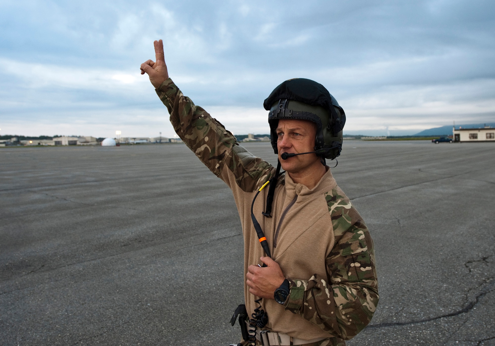 JOINT BASE ELMENDORF-RICHARDSON, Alaska -- Royal Air Force Flight Sgt. Mark Oakman, a member of the No. 47 Squadron from Brize Norton Station, United Kingdom, communicates with a U.K. C-130 Hercules during Red Flag-Alaska 11-3 Aug. 22. The 47th traveled from the U.K. with 56 members of the RAF to participate in RF-Alaska. While here, they will work on enhancing their skills in cargo-air drops, electronic warfare, assault-strip landings and more. (U.S. Air Force photo/Senior Airman Christopher Gross)