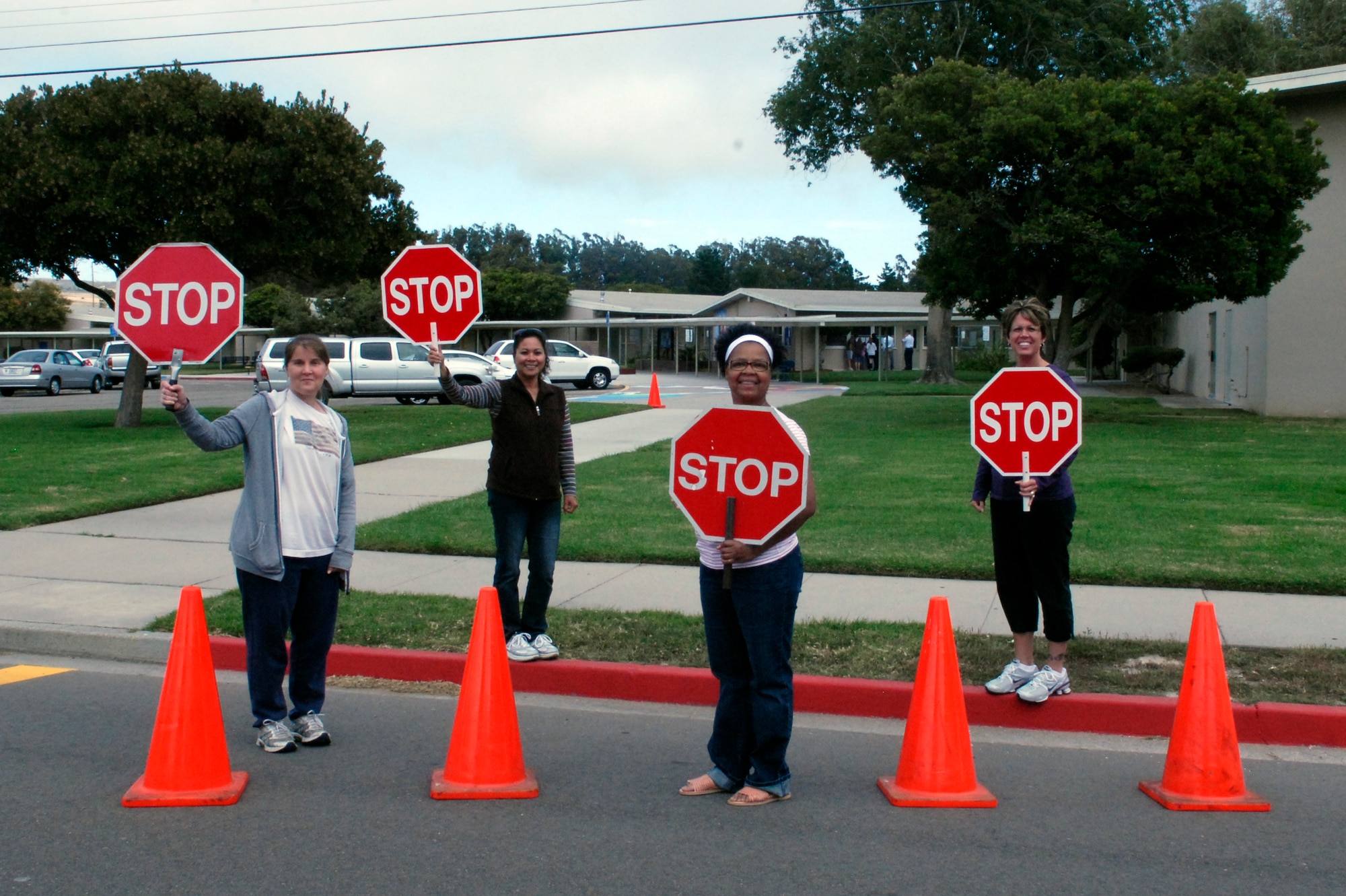 VANDENBER AIR FORCE BASE, Calif. -- Lana Masters, Tess Davis, Darlene Kirksy and Trish Wallace, Crestview Elementary School crossing guards, get ready for the start of the new school year Monday, Aug. 22, 2011 Drivers are urged to observe posted speed limit signs and watch for children who are on their way to and from school.  (US Air Force photo/Jennifer Green-Lanchoney) 