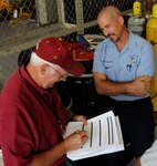 Bob Chabot (left), Air Education and Training Command Environmental, Safety and Occupational Health Compliance Assessment and Management Program inspector, evaluates the 12th Flying Training Wing Hazardous Waste Program while Greg Fruscella, 12th FTW Hazardous Waste Program environmental manager, facilitates the ESOHCAMP inspection process at Randolph Air Force Base Aug. 23 ( U.S. Air Force Photo by Don Lindsey)