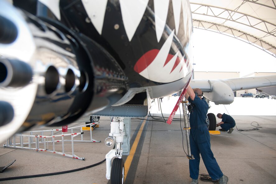 U.S. Air Force Staff Sgts. Ryan Ball, foreground, A-10 East Demonstration Team avionics specialist, and Adam Sunner, A-10 East Demo Team crew chief, repair an A-10C Thunderbolt II at Moody Air Force Base, Ga., Aug. 24, 2011. Ball and Sunner worked on the plane to get it ready for their show on Aug. 25-29. (U.S. Air Force photo by Airman 1st Class Paul Francis/Released)
