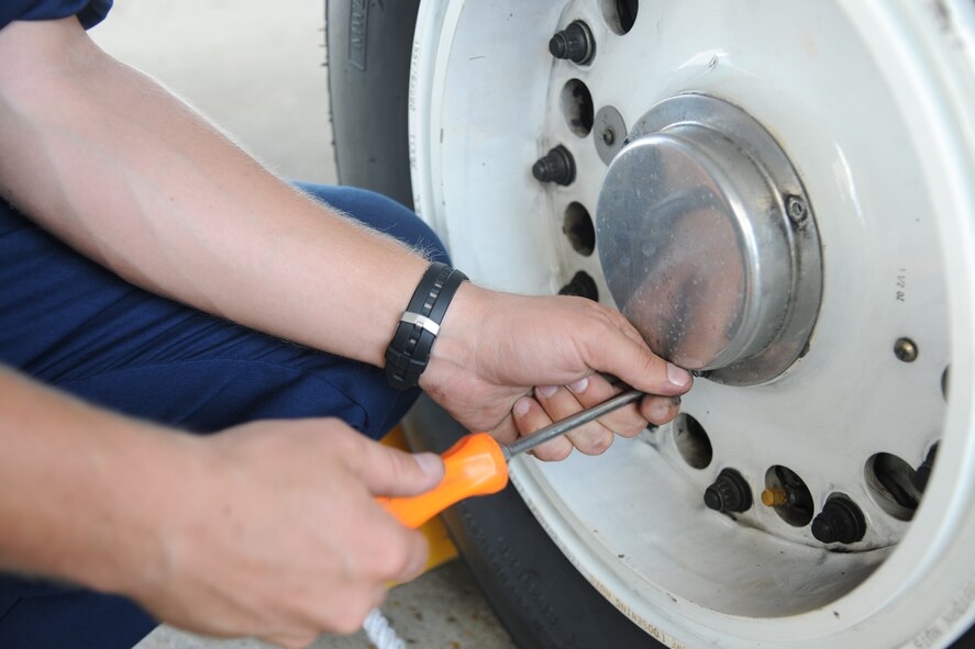 U.S. Air Force Staff Sgt. Adam Sunner, A-10 East Demonstration Team crew chief, prepares to unscrew a tire cap on an A-10C Thunderbolt II at Moody Air Force Base, Ga., Aug. 24, 2011. Sunner performed an anti-skid ops check to make sure the tires had proper air pressure. (U.S. Air Force photo by Airman 1st Class Paul Francis/Released)