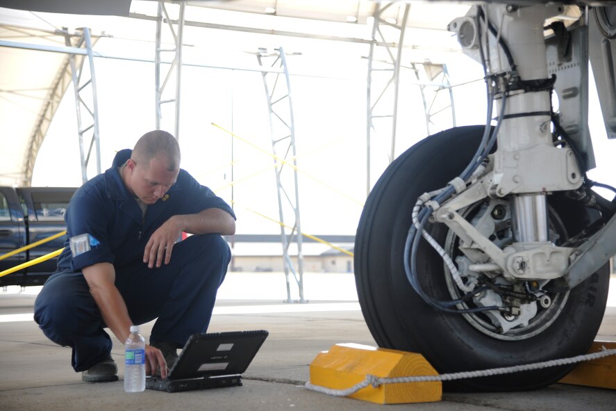 U.S. Air Force Staff Sgt. Ryan Ball, A-10 East Demonstration Team avionics specialist, runs through a check of items needed during the repair of an A-10C Thunderbolt II at Moody Air Force Base, Ga., Aug. 24, 2011. The checks consisted of hydraulic tests, anti-skid checks and operational checks. (U.S. Air Force photo by Airman 1st Class Paul Francis/Released)