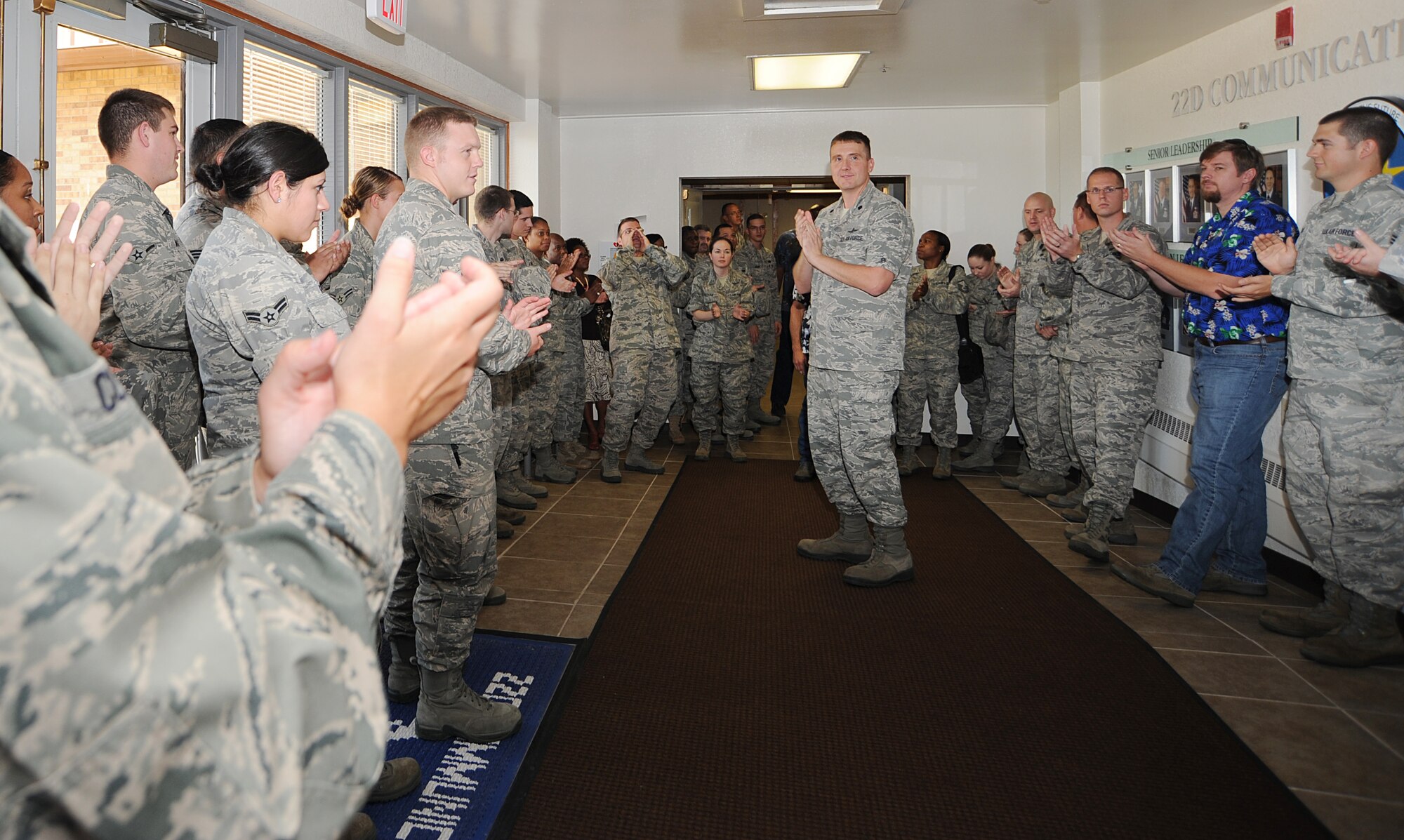 Lt. Col. Robert Schroeter, 22nd Communications Squadron commander, applauds members of the 22nd CS Aug. 19, 2011, McConnell Air Force Base, Kan.  Schroeter gathered the members to congratulate the squadron on earning an “Outstanding” rating on the non-secure and secret internet protocol router networks during a Command Cyber Readiness Inspection. The Defense Information Systems Agency conducted the CCRI to assess McConnell’s Information Assurance readiness and evaluate the base’s cyber security program.  (U.S. Air Force photo/Senior Airman Maria A. Ruiz)