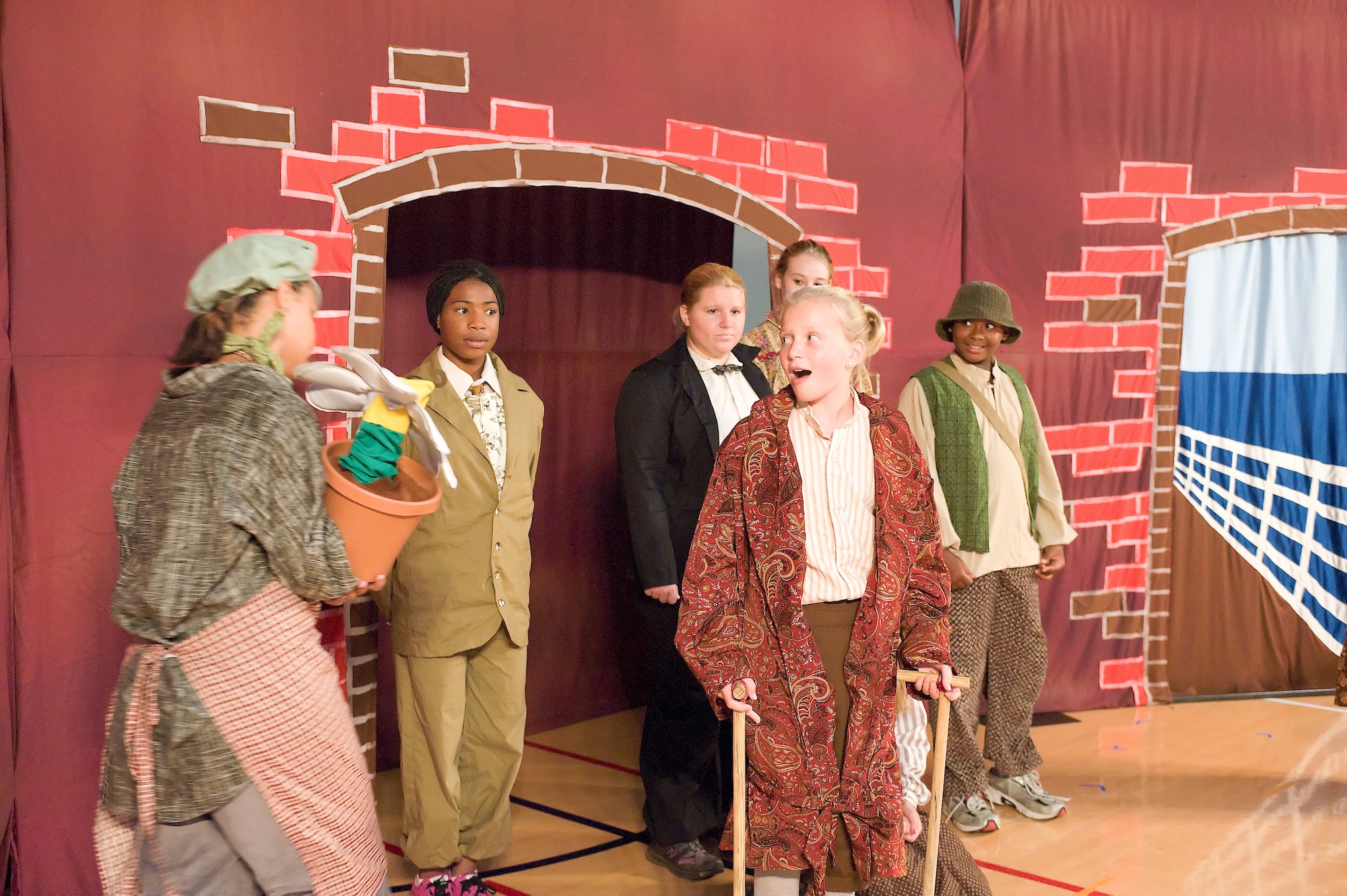 Youth Center members act out a scene from “The Secret Garden” Aug. 19, 2011, at the Youth Center gymnasium. More than 60 children and teenagers participated in the production for more than 160 audience members. (U.S. Air Force photo by Steve Kotecki)