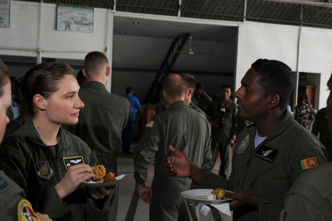 Senior Airman Monica Oshin has a conversation with Sri Lanka Air Force Flt. Sgt. Adika Riarachichi during a meet-and-greet session for the start of Pacific Airlift Rally 2011 Aug. 22, 2011, at Ratmalana Airport, Colombo, Sri Lanka on Aug. 22 for the start of Pacific Airlift Rally 2011. PAR is a Pacific Air Force sponsored, biennial multilateral tactical military airlift symposium. The exercise enhances military airlift interoperability and cooperation between the nations of the Indo-Pacific region. (Department of Defense photo/Master Sgt. Cohen A. Young)

