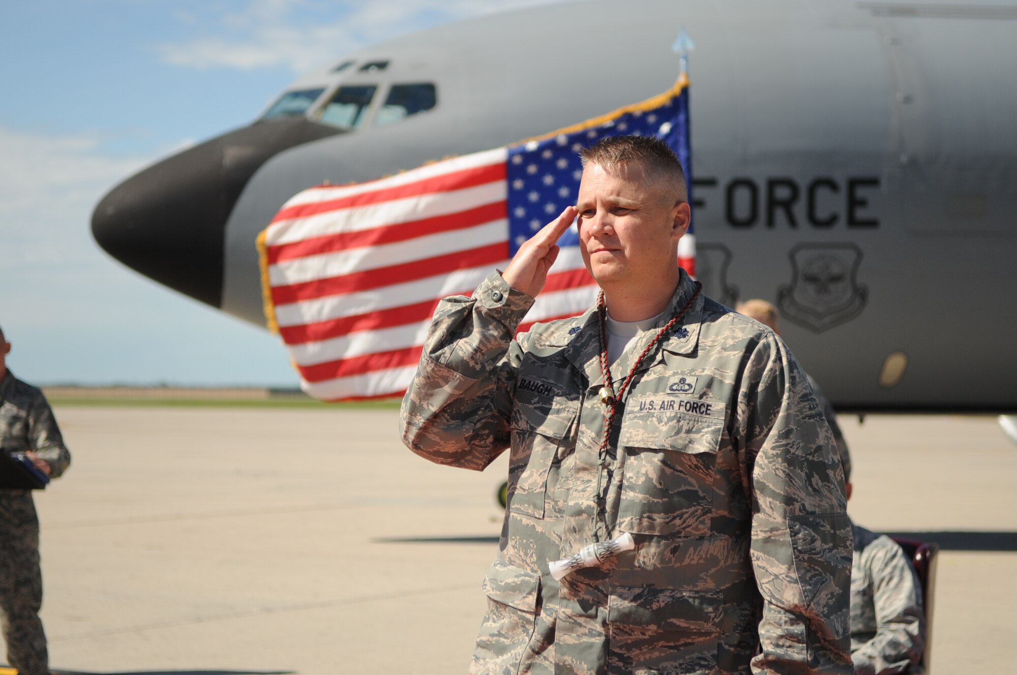 Lt. Col Bradley Baugh, commander of the 319th Operation Support Squadron, receives his first salute as new commander during the 319th OSS Change of Command on Grand Forks Air Force Base Aug. 19. The Change of Command is a time-honored tradition in the military which visibly assures continuity of command. This is represented by the unit flag being passed from the present commander to the future commander. (U.S Air Force photo by Senior Airman Amanda N. Stencil)
