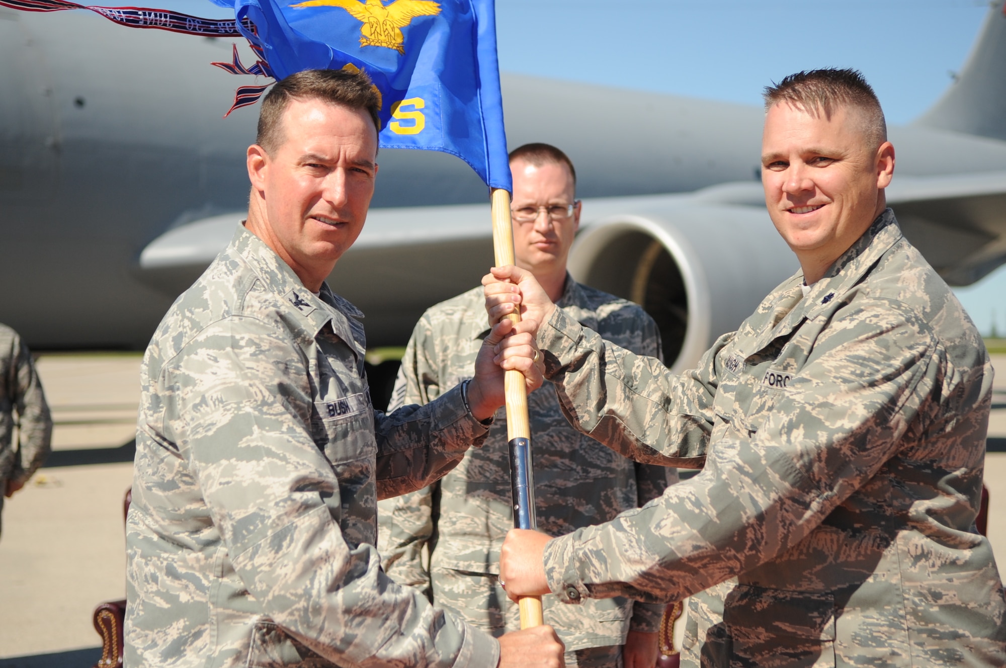 Lt. Col. Bradley Baugh, commander of the 319th Operation Support Squadron, receives the guidon from Col. Timothy Bush, commander of the 319th Air Base Wing during the 319th OSS Change of Command on Grand Forks Air Force Base Aug. 19. Colonel Baugh formerly served as the 319th Air Base Wing chief of safety and now takes over the responsibility and privilege of leading 137 Airmen providing support through Air Traffic Control, Radar Control, Base Operations, Life Support, Tower Operations and Airfield Management. The Change of Command is a time-honored tradition in the military which visibly assures continuity of command. This is represented by the unit flag being passed from the present commander to the future commander. (U.S Air Force photo by Senior Airman Amanda N. Stencil)