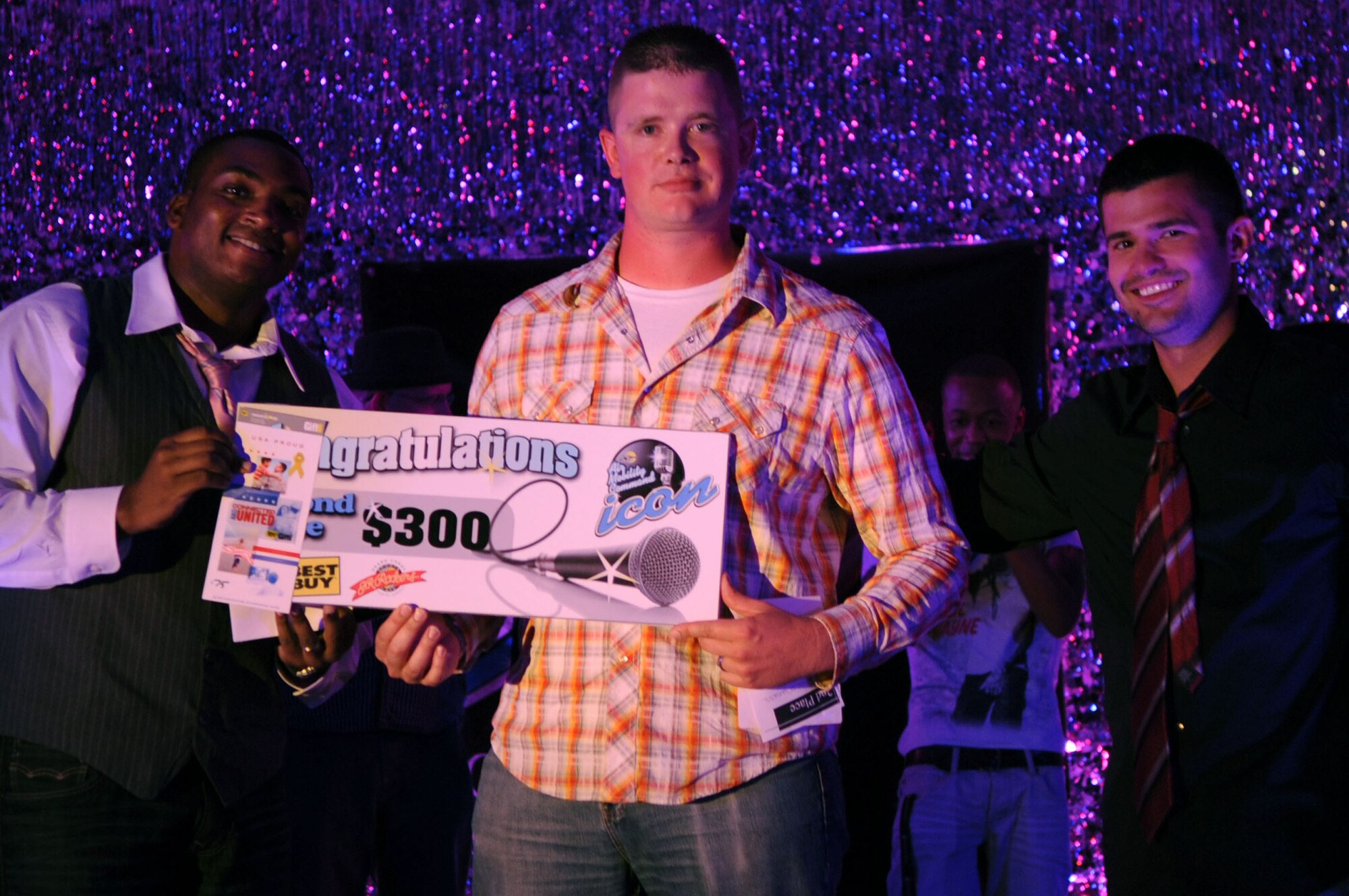 Senior Airman Josh Maness, from the 319th Logistics Readiness Squadron, receives his 2nd place prize at the Air Mobility Command Icon Contest on Grand Forks Air Force Base Aug 18. AMC Icon’s contest is conducted annually and is a great way for GFAFB members to be center stage while highlighting their talents. Airman Maness will represent GFAFB at AMC Headquarters Scott AFB. (U.S. Air Force photo by Senior Airman Amanda N. Stencil)
