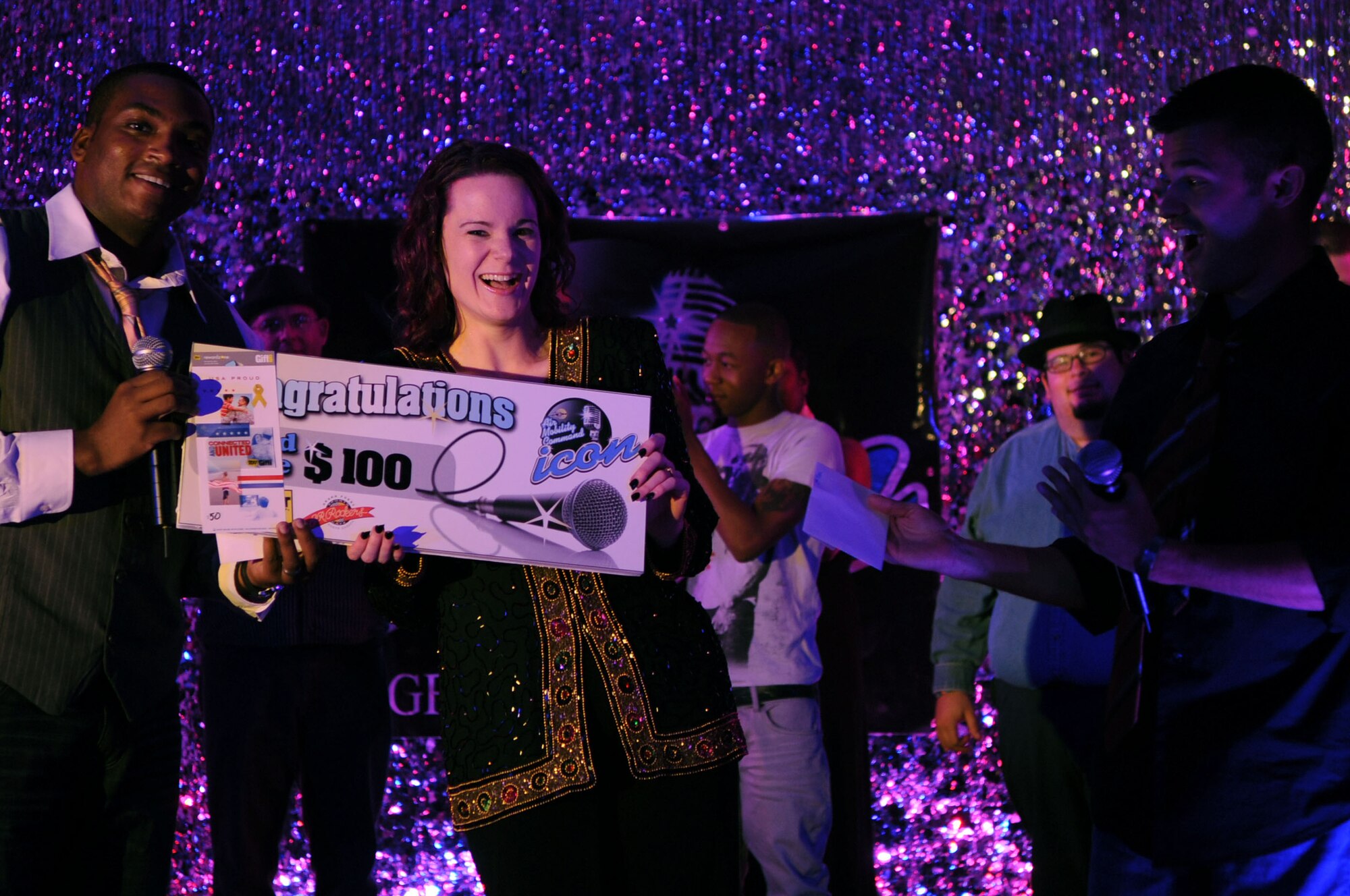 Performer Rebecca Shelton, AAFES employee, receives her 3rd place prize at the Air Mobility Command Icon Contest on Grand Forks Air Force Base Aug 18. AMC Icon’s contest is conducted annually and is a great way for GFAFB members to be center stage while highlighting their talents. The AMC Icon’s top performer will represent GFAFB at AMC Headquarters Scott AFB Illinois in October. (U.S. Air Force photo by Senior Airman Amanda N. Stencil)