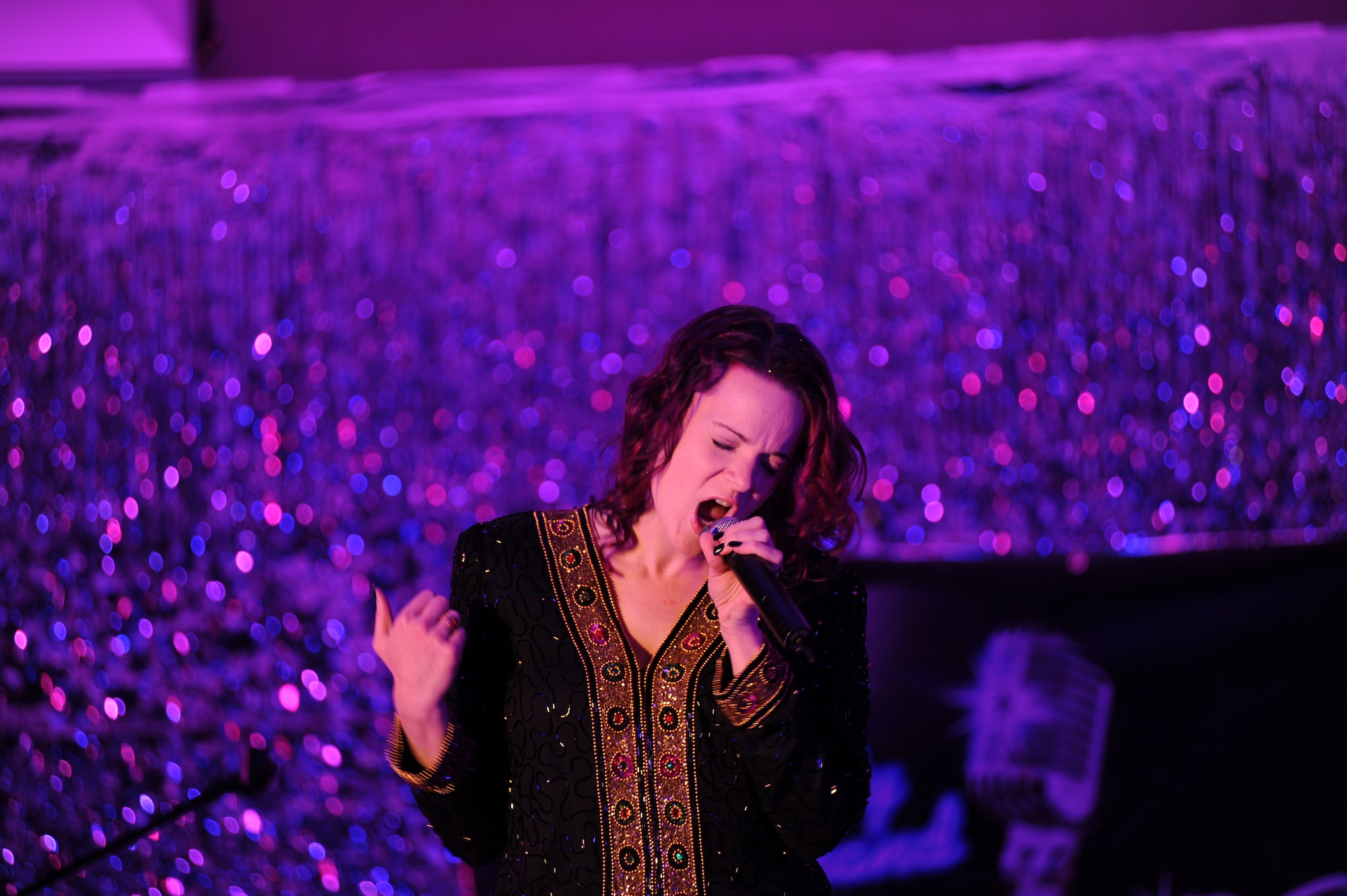 Rebecca Shelton, AAFES employee, performs an original song “I Need Your Love” at the  Air Mobility Command Icon Contest on Grand Forks Air Force Base Aug 18. AMC Icon’s contest is conducted annually and is a great way for GFAFB members to be center stage while highlighting their talents. The AMC Icon’s top performer will represent GFAFB at AMC Headquarters Scott AFB Illinois in October. (U.S. Air Force photo by Senior Airman Amanda N. Stencil)