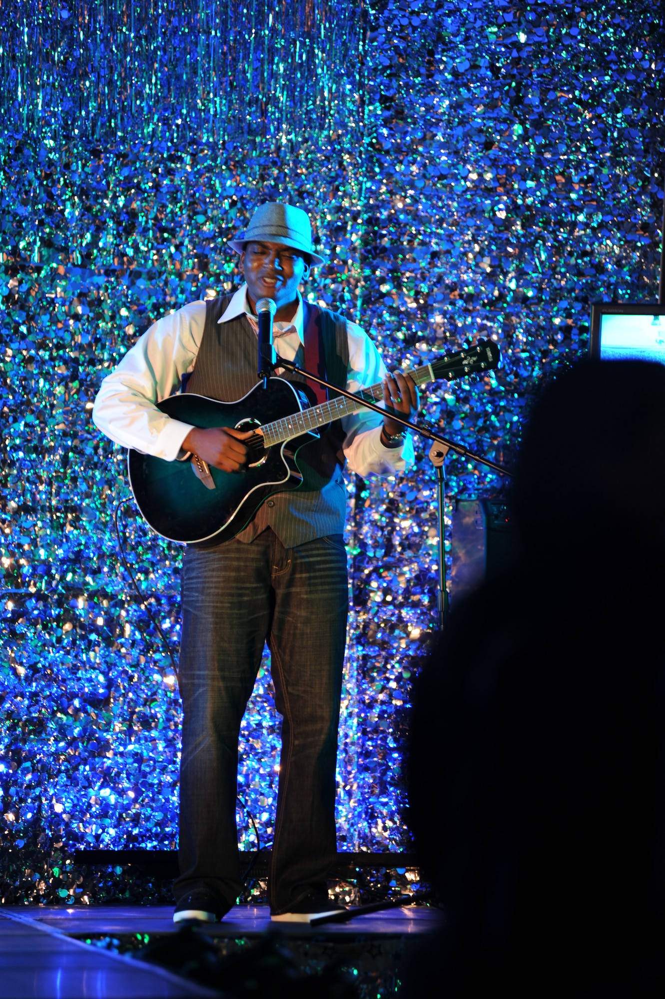 Senior Airman Marshall Merriweather, member of the 319th Logistics Readiness Squadron, sings during the Air Mobility Command Icon on Grand Forks Air Force Base Aug 18. AMC Icon’s contest is conducted annually and is a great way for GFAFB members to be center stage while highlighting their talents. The AMC Icon’s top performer will represent GFAFB at AMC Headquarters Scott AFB Illinois in October.  (U.S. Air Force photo by Senior Airman Amanda N. Stencil)