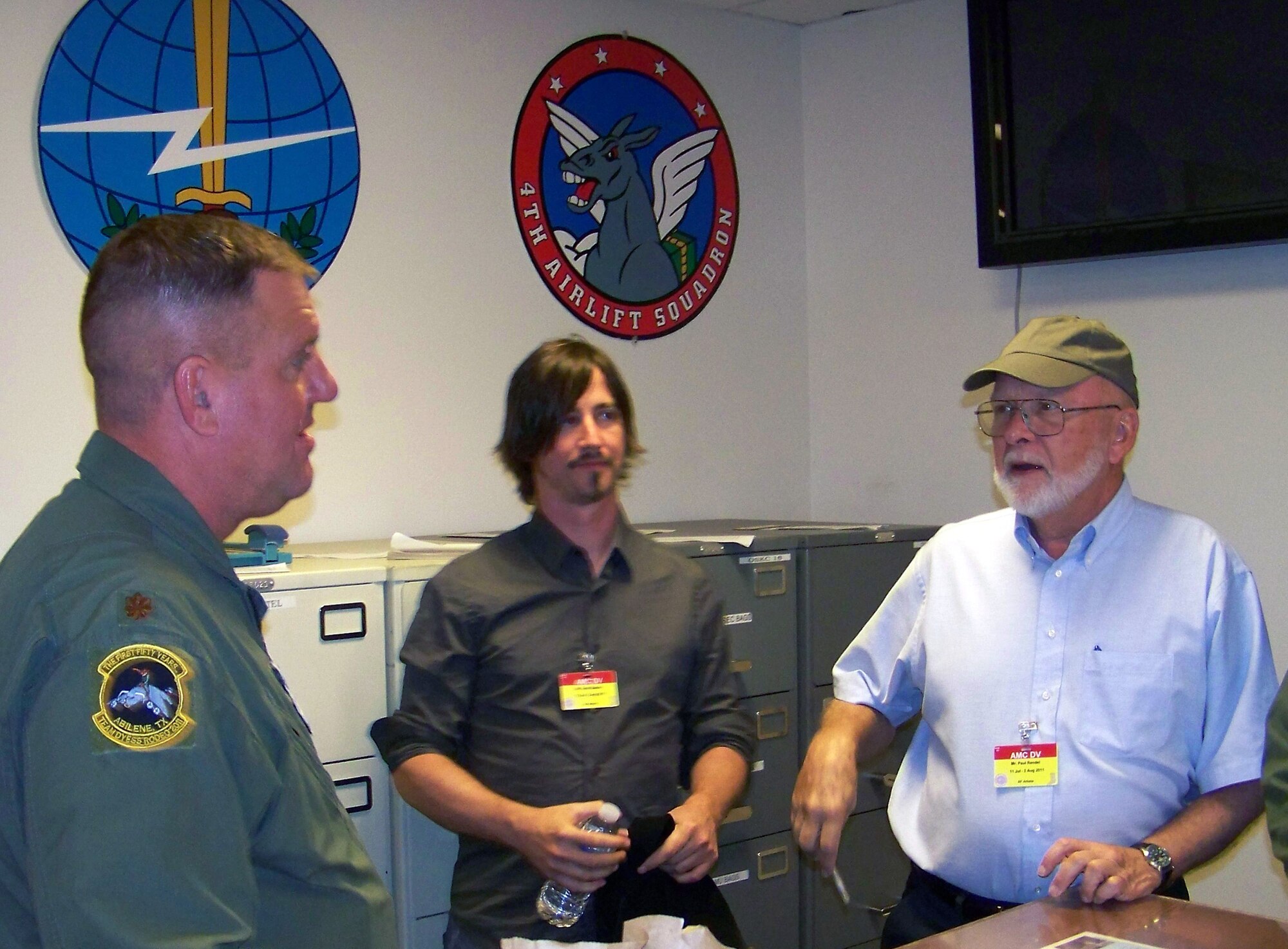 Artists Scott Bakal and Paul Rendel (center and right), talk with an aircrew member during their visit to Air Mobility Rodeo 2011 at Joint Base Lewis-McChord, Wash., on July 28, 2011. Bakal is from Boston, Mass., and Rendel is from Milton, Del. Both are also part of the New York Society of Illustrators. The artists visit to Rodeo was coordinated through the Air Mobility Command History Office. (Courtesy Photo)