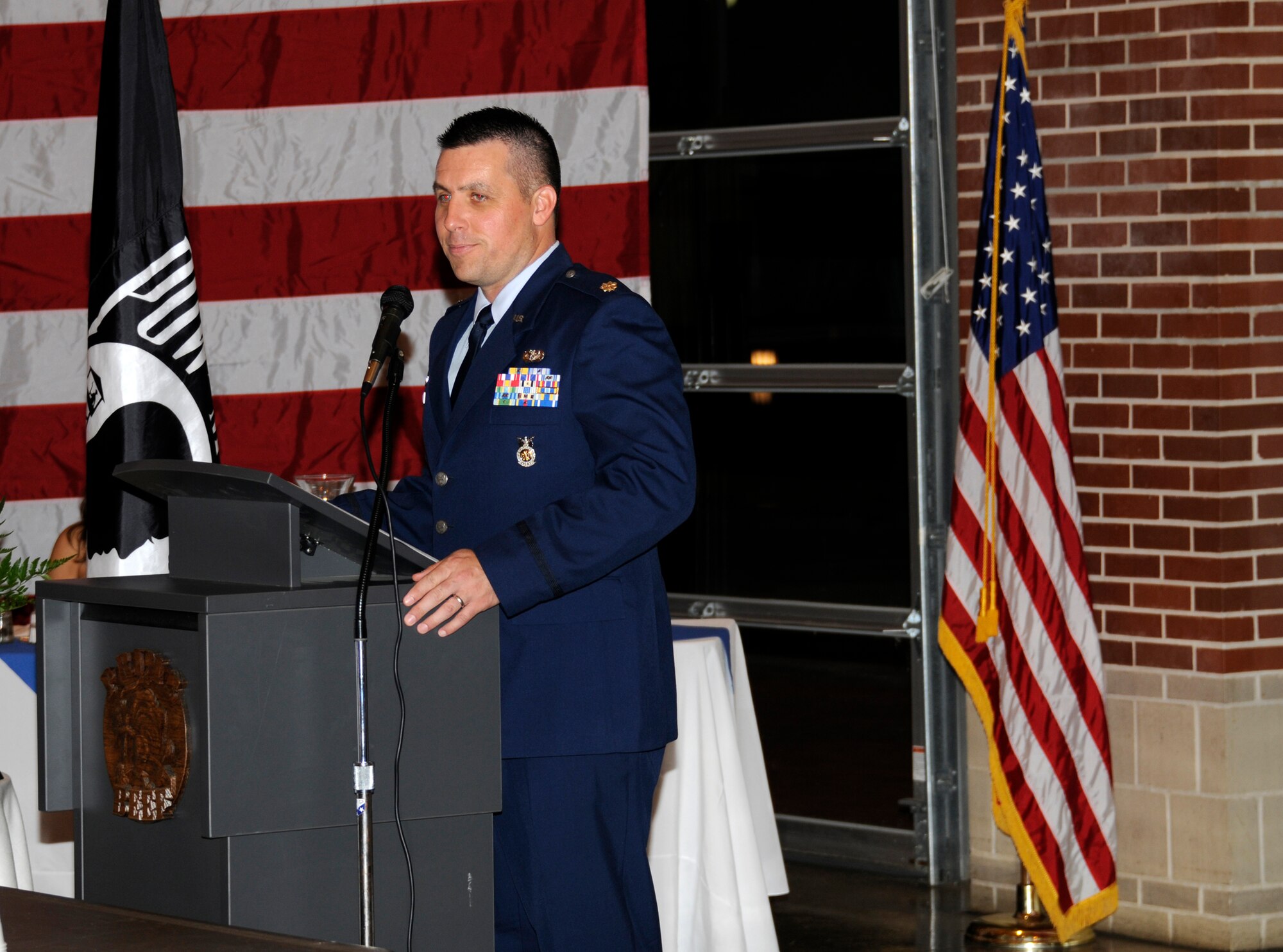 Maj. Joe Harrison, 188th Civil Engineering Squadron commander, speaks to members of his unit Aug. 10 at a formal dining-in ceremony held in Fort Smith. The objective of the event was to help foster squadron camaraderie before the unit ventured to Tyndall Air Force Base, Fla., to participate in Exercise Silver Flag during annual training. (U.S. Air Force photo by Senior Master Sgt. Dennis Brambl)