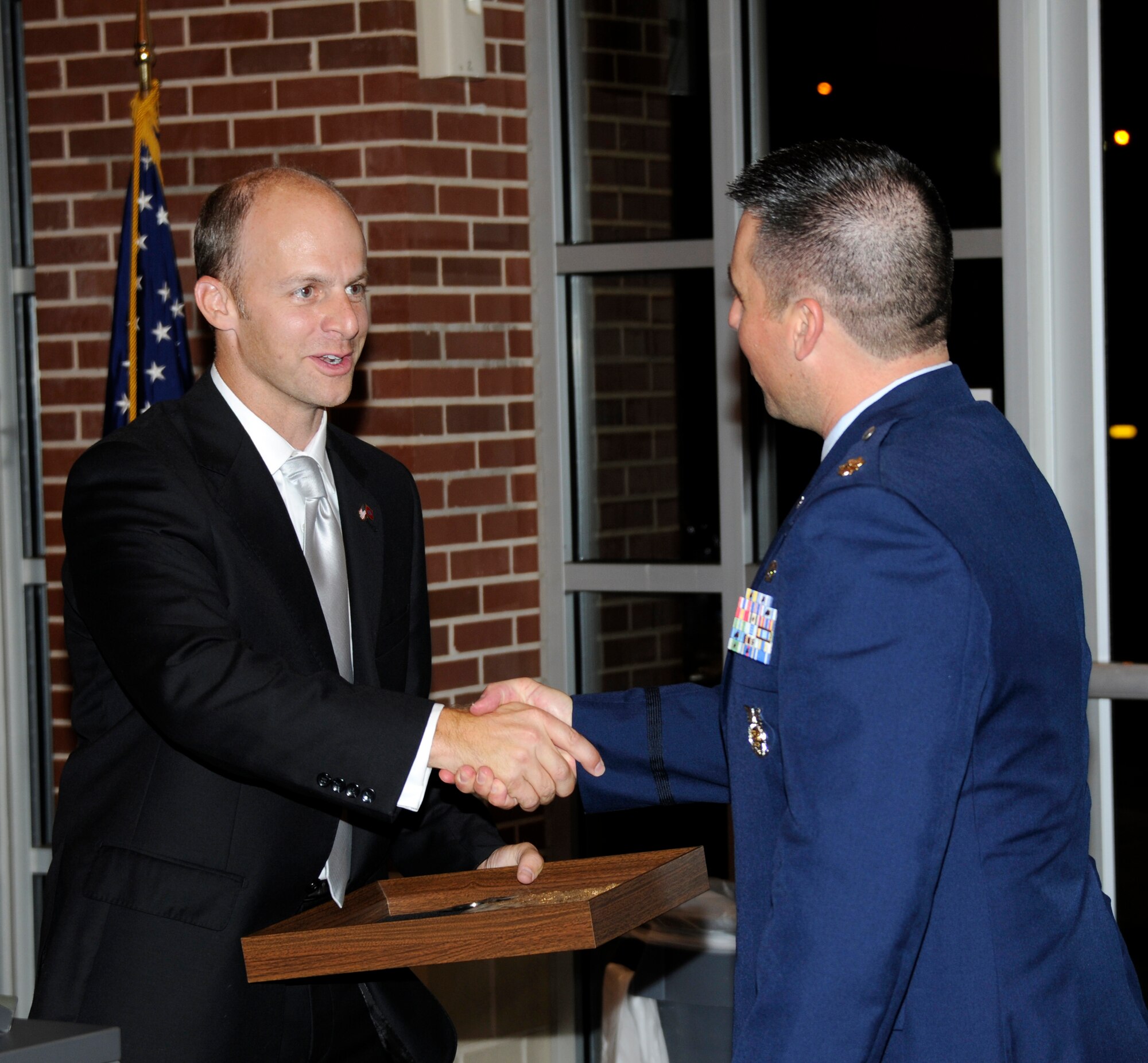 Arkansas Senator Jake Files, left, shakes hands with Maj. Joe Harrison, 188th Civil Engineering Squadron commander, Aug. 10 at a formal dining-in ceremony held in Fort Smith. Senator Files was the event’s guest speaker. The objective of the event was to help foster squadron camaraderie before the unit ventured to Tyndall Air Force Base, Fla., to participate in Exercise Silver Flag during annual training. (U.S. Air Force photo by Senior Master Sgt. Dennis Brambl)