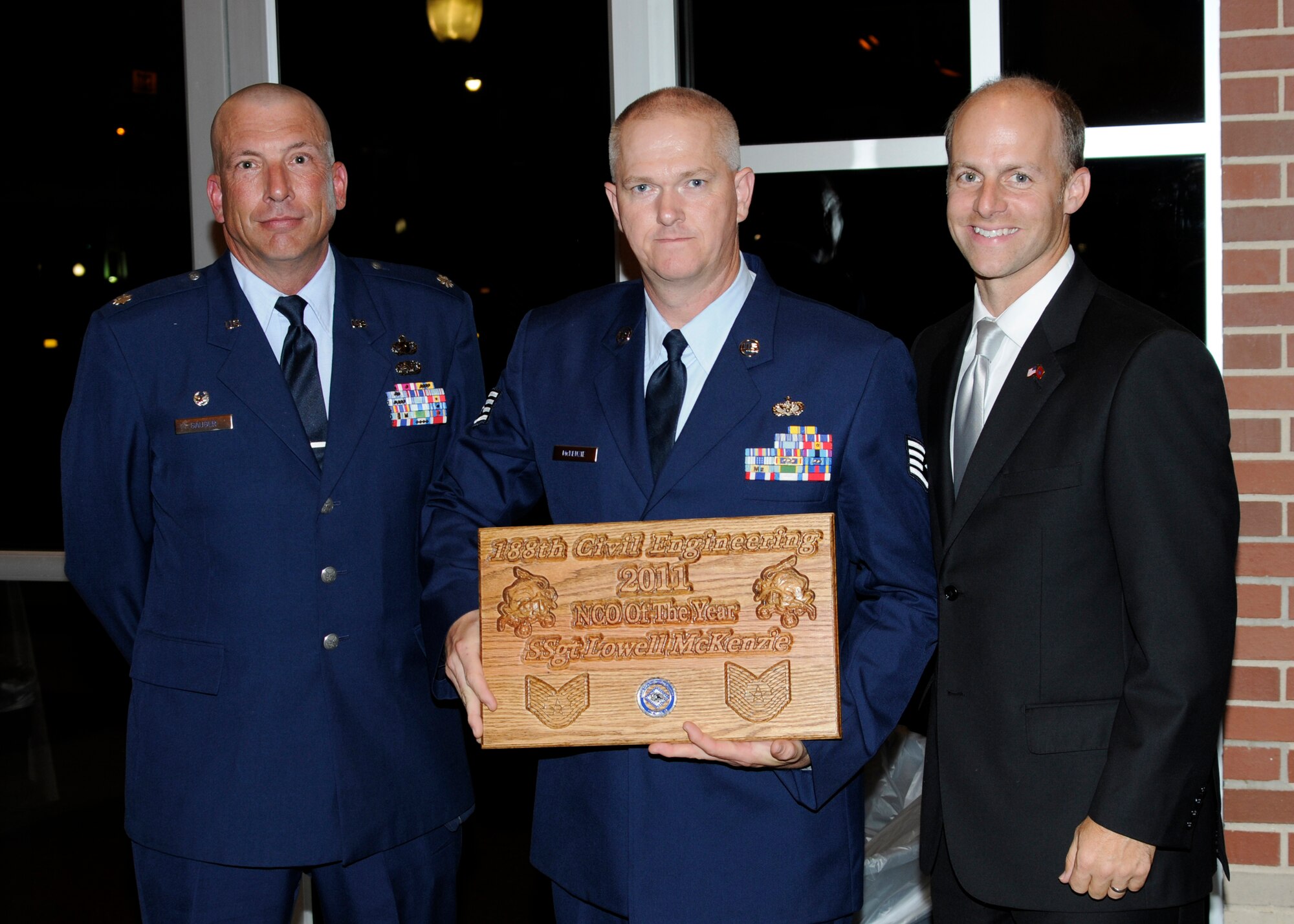 From left: Lt. Col. Pete Gauger, 188th Mission Support Group commander; Staff Sgt. Lowell McKenzie, 188th Civil Engineering Squadron Noncommissioned Officer of the Year for 2011; and Arkansas Senator Jake Files. Senator Files was the guest speaker at the 188th CES’ formal dining-in ceremony Aug. 10. Sergeant McKenzie was named the squadron’s most outstanding NCO during the event. (U.S. Air Force photo by Senior Master Sgt. Dennis Brambl)

