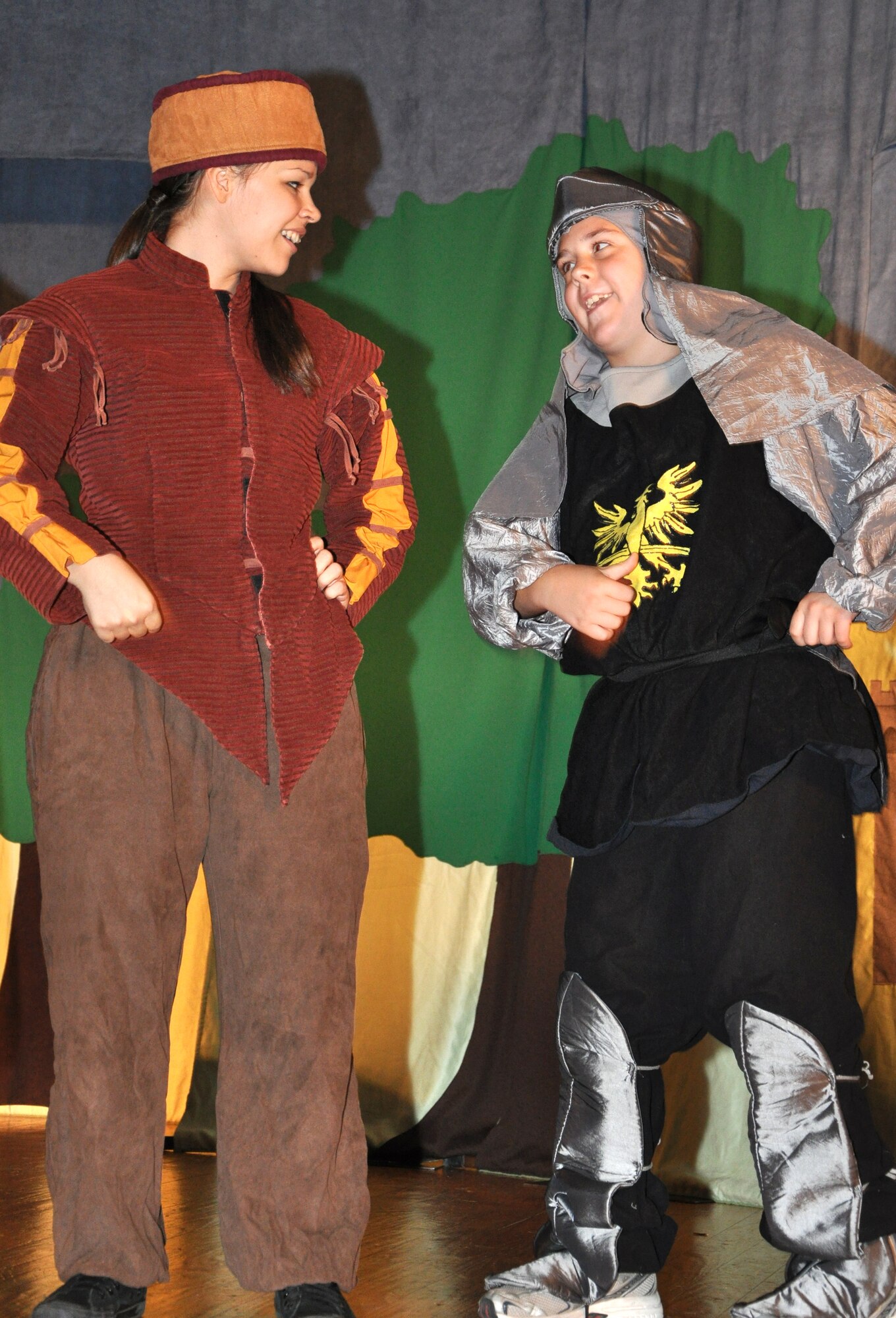 GOODFELLOW AIR FORCE BASE, Texas -- (From left:) Keeper of the Keep, Loretta Underwood, and Black Knight, Ethan Hunnemeyer, talk about each knight's speciality during the Missoula Children's Theatre production of King Arthur's Quest Aug. 20 at the base theater here.  More than 50 youths participated in this year's play with was cast and rehearsed in one week.  (U.S. Air Force photo/Connie Hempel)