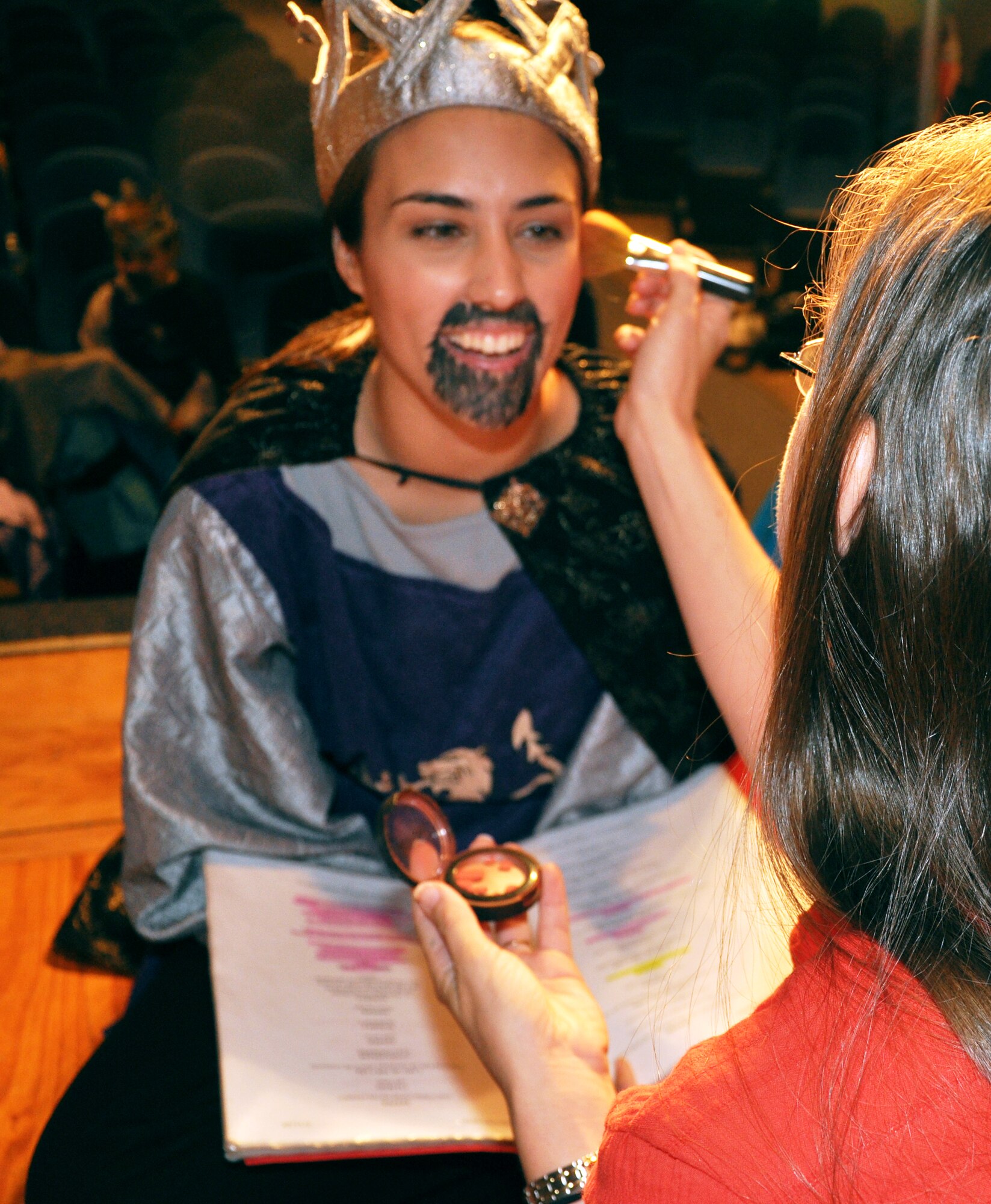 GOODFELLOW AIR FORCE BASE, Texas -- Emily Hunnemeyer takes a last look at her lines during the make-up session of the Missoula Children's Theatre production of King Arthur's Quest Aug. 20 at the base theater here.  More than 50 base youths participated in this year's play which was cast and rehearsed in one week.  (U.S. Air Force photo/Connie Hempel)