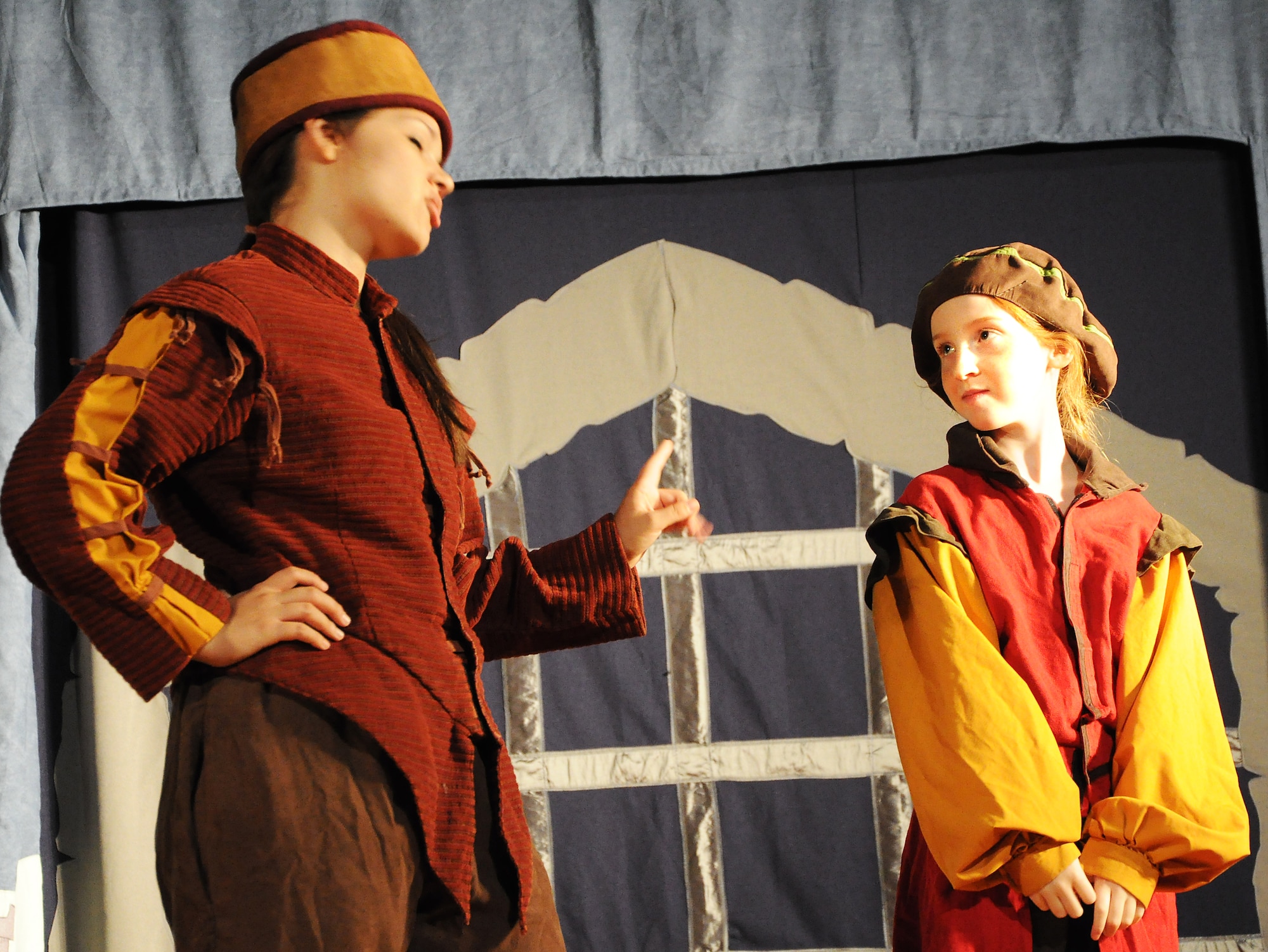 GOODFELLOW AIR FORCE BASE, Texas -- (From left:) Keeper of the Keep, played by Loretta Underwood, tells Taleisin, played by Katharine Ingalls, not to encourage Merlin and his faulty magic during the Missoula Children's Theatre production of King Arthur's Quest Aug. 20 at the base theater here. The Missoula Children's Theater travels to nearly 1,300 communities in the United States and in 17 other countries each year. (U.S. Air Force photo/Connie Hempel)