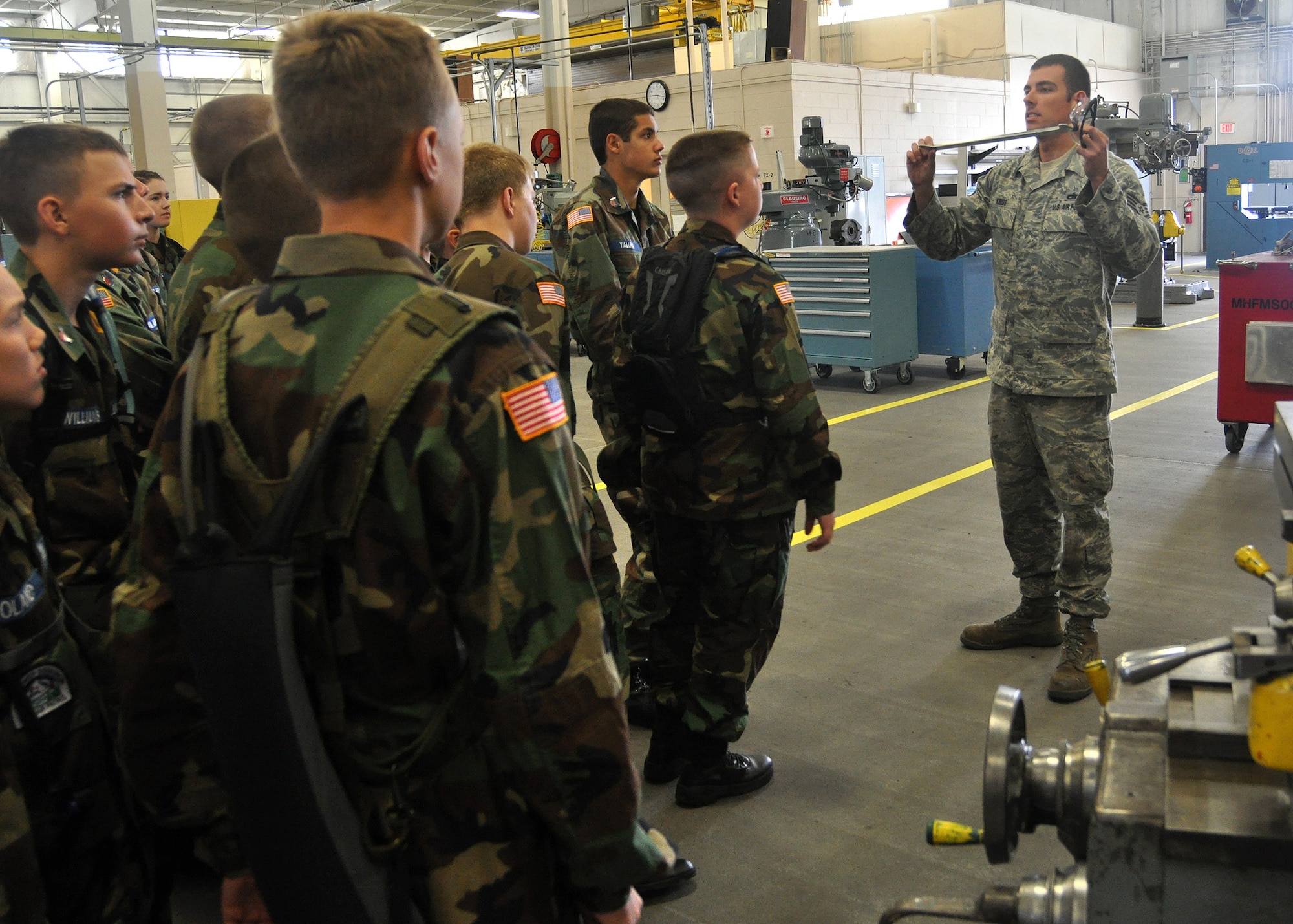 Staff Sgt. Brad Kriss, 62nd Maintenance Squadron, describes his responsibilities in the fabrication flight to a group of Civil Air Patrol cadets August 15, 2011, at Joint Base Lewis-McChord, Wash. The group toured organizations around the wing such as the Fire Department, Air Traffic Control Tower and the Aerial Port Squadron. (U.S. Air Force photo/Airman 1st Class Leah Young)