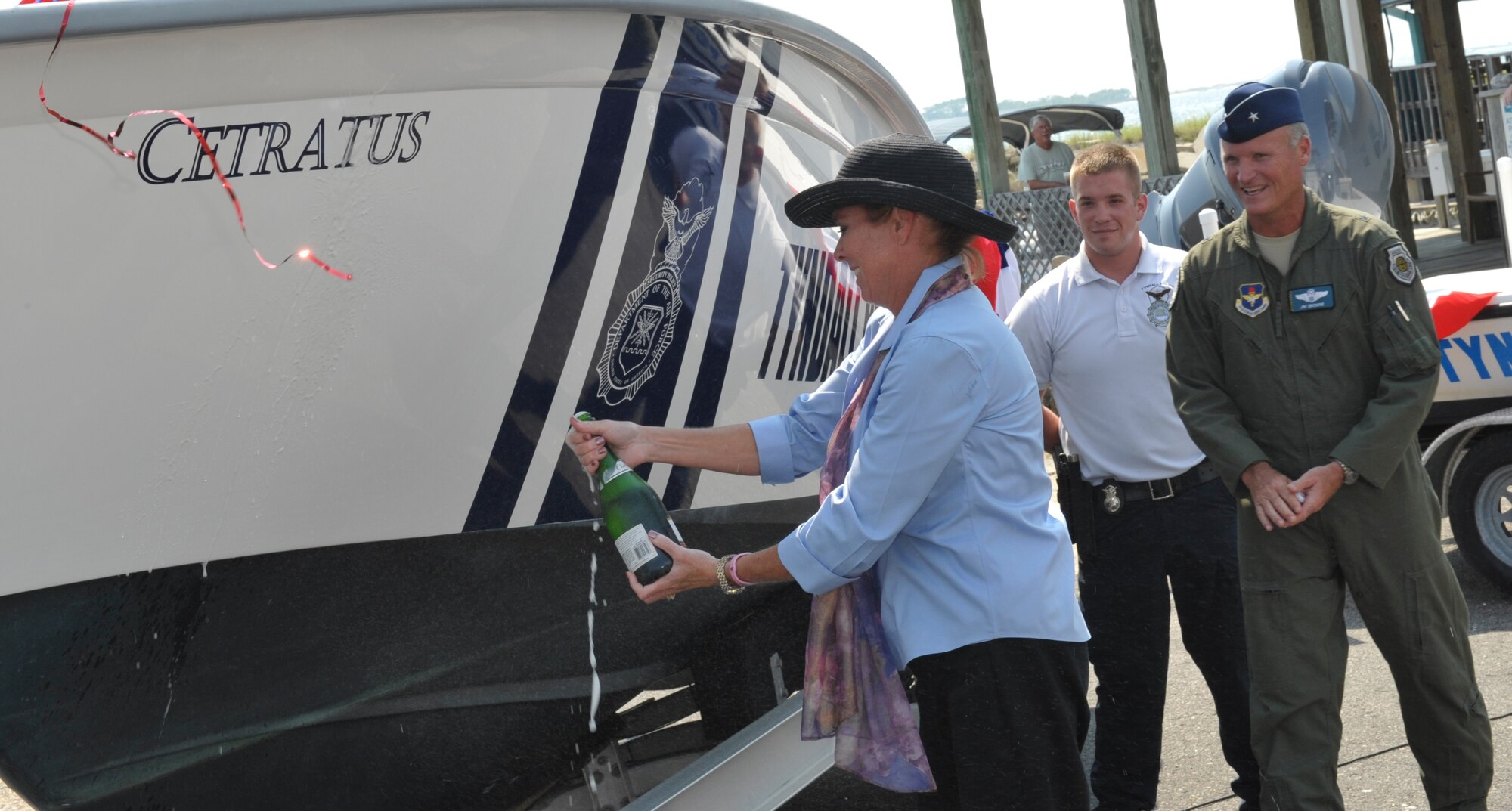 Alison Browne, 325th Fighter Wing commander’s wife, christens the 325th Security Forces’ patrol boat, Cetratus, during a christening ceremony at the marina, Aug. 19. (U.S. Air Force photo by Jonathan Gibson)