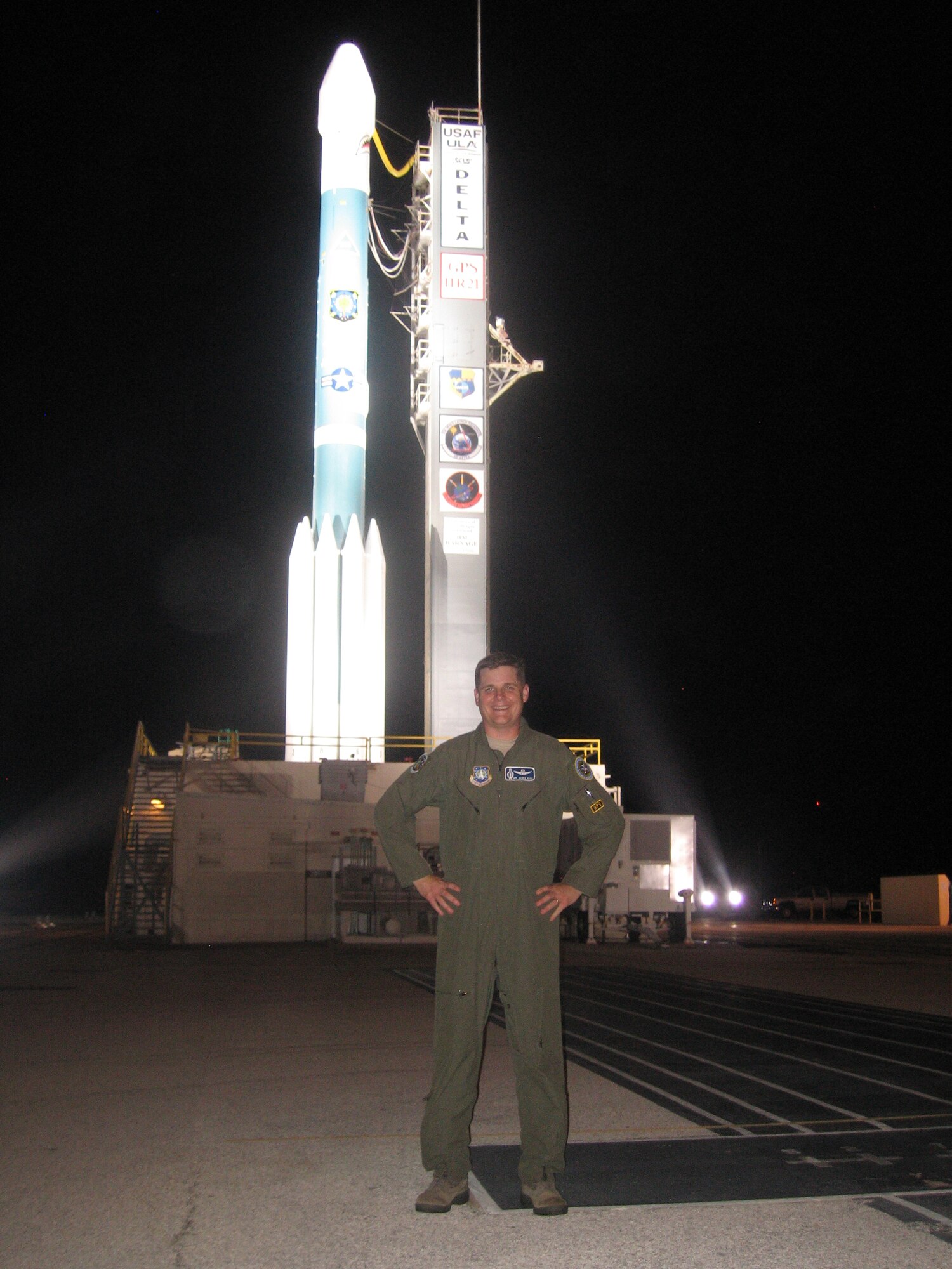 Lt. Col. William Burke Hare III, then part of Air, Space and Cyberspace Operations, Air Force Space Command, stands in front of a Delta II rocket that will launch the last GPS IIR, Aug. 16, 2009. (Courtesy photo)
