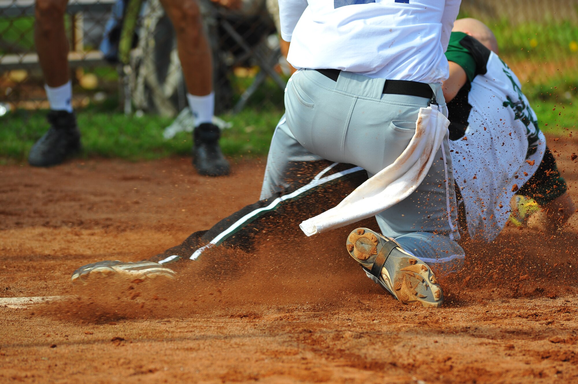 SPANGDAHLEM AIR BASE, Germany –Wade Jacobson, Allied Joint Force Command Naples, Italy, slides into home plate against George Gomes, catcher from Incirlik Air Base, during the U.S. Armed Forces in Europe softball championship here Aug. 19. Naples beat the Incirlik Sultans 12-5 in this preliminary game. The Ramstein Lady Rams beat the Lakenheath Lady Eagles 5-4, and the Ramstein Rams beat the Aviano Dragons 28-16 in the final championship games. Both male and female U.S. Forces softball teams from the Army and Air Force, including the Spangdahlem Saber teams, participated in the annual event. (U.S Air Force photo/Airman 1st Class Dillon Davis)