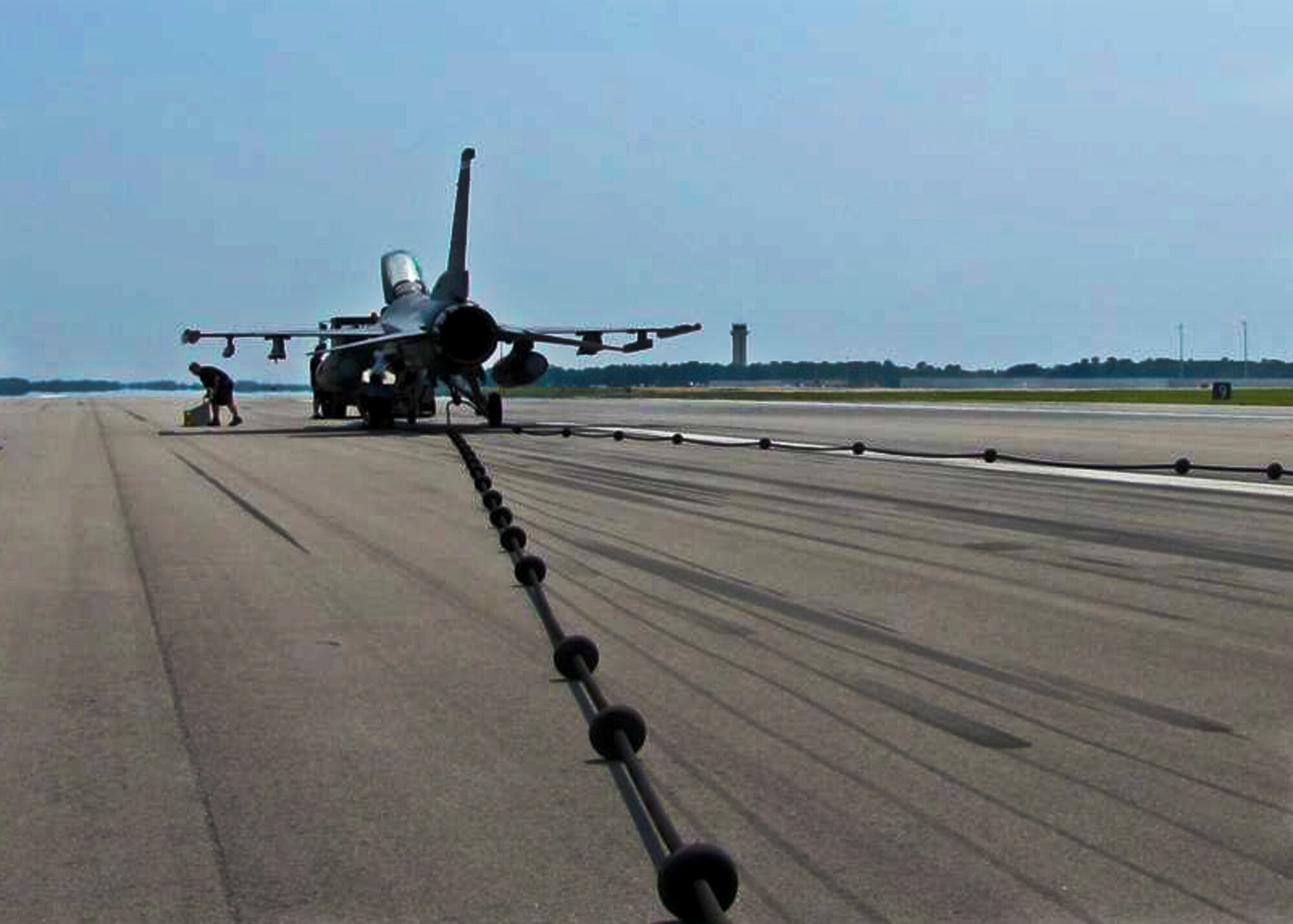 An F-16 Fighting Falcon tests the BAK-12 cable system on Eglin's recently renovated runway Aug. 22.  The aircraft completed a high-speed taxi engagement and pull at the targeted speed of 115 knots to certify the system was working properly.  (Courtesy photo)