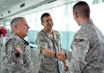 Senior Airman Chris Jones of the 138th Security Forces Squadron, is greeted by Brigadier General Michael Hepner, 138th Fighter Wing Commnader, and  Major General Myles Deering, Adjutant General for the state of Oklahoma.  SrA. Jones and other 138th SFS members returned home after a six month deployment to Afghanistan.  Family, Friends, and co workers from the 138th Fighter Wing, Oklahoma Air National Guard,  gathered at the Tulsa International Airport to welcome the Airmen home.  (Official U.S. Air Force photo by Master Sergeant Preston L. Chasteen)