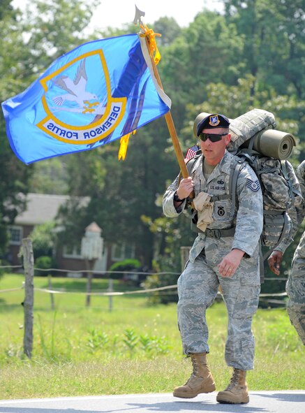 SEYMOUR JOHNSON AIR FORCE BASE, N.C. - Tech. Sgt. David Leebert, 4th Security Forces Squadron readiness NCOIC, carries the Defender Fortis guidon during the 9/11 Ruck March to Remember, Aug. 21, 2011. Once the security forces flag nears ground zero, a joint installation security forces team will march with it in on Sept. 11. The march began at Lackland Air Force Base, Texas and consists of 15 security forces squadrons covering 2,182 miles to ground zero in New York. Leebert hails from Sacramento, Calif.  (U.S. Air Force photo by Senior Airman Gino Reyes/Released)

