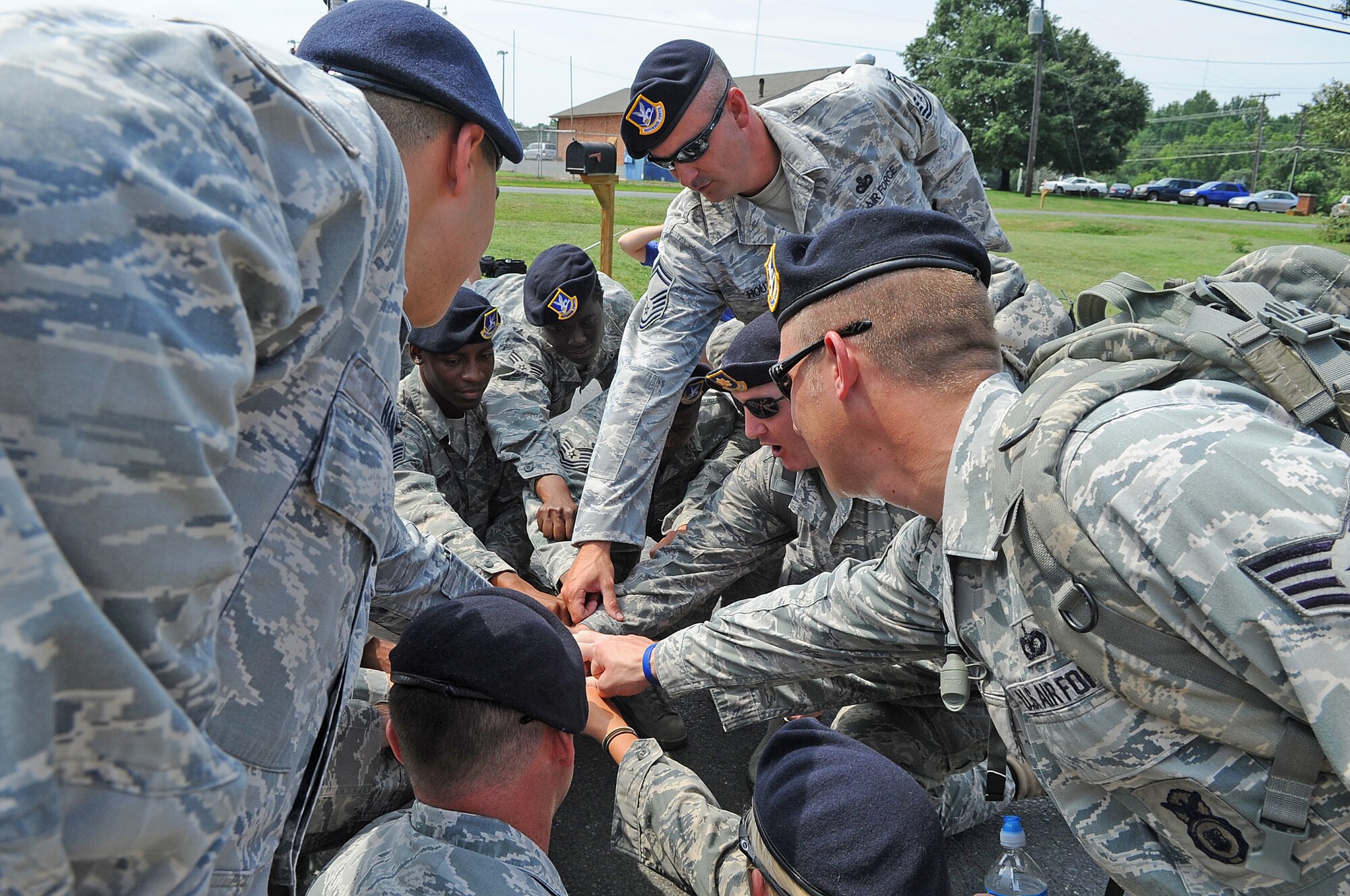 SEYMOUR JOHNSON AIR FORCE BASE, N.C.- Airmen from the 4th Security Forces Squadron gather prior to the passing of the guidon during the 9/11 Ruck March to Remember Aug. 21, 2011. The march is dedicated to the defenders who lost their lives and were injured since the terrorist attacks Sept. 11, 2001. The march began at Lackland Air Force Base, Texas and consists of 15 security forces squadrons covering 2,182 miles to ground zero in New York.   (U.S. Air Force photo by Senior Airman Gino Reyes/Released)