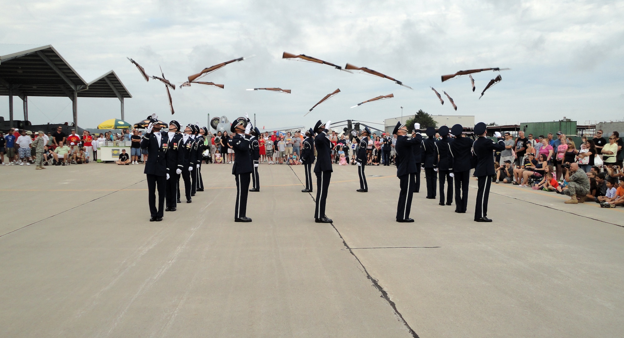 The U.S. Air Force Drill Team performs a precision maneuver in which each member of the drill team tosses his or her rifle to the Airman behind him. The Drill Team performed during the 2011 Selfridge Air Show and Open House at Selfridge Air National Guard Base, Mich., Aug. 20, 2011. (USAF photo by Staff Sgt. Bradley Moehlig)