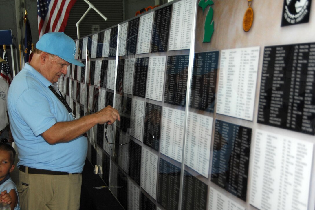 A veteran looks at a the Michigan Vietnam Veterans Traveling Memorial honoring Michigan residents who died in combat during the Vietnam War. The memorial, maintained by the Vietnam Veterans of America chapter 154, was on display as part of the Selfridge Air Show and Open House at Selfridge Air National Guard Base, Mich., Aug. 20, 2011. (USAF photo by John S. Swanson)