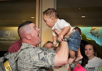 Master Sergeant Irvon Stout of the 138th Security Forces Squadron, greets his grandson  Landon Reed after returning home from a six month deployment to Afghanistan.  Family, Friends, and co workers from the 138th Fighter Wing, Oklahoma Air National Guard,  gathered at the Tulsa International Airport to welcome the Airmen home.  (Official U.S. Air Force photo by Master Sergeant Preston L. Chasteen)