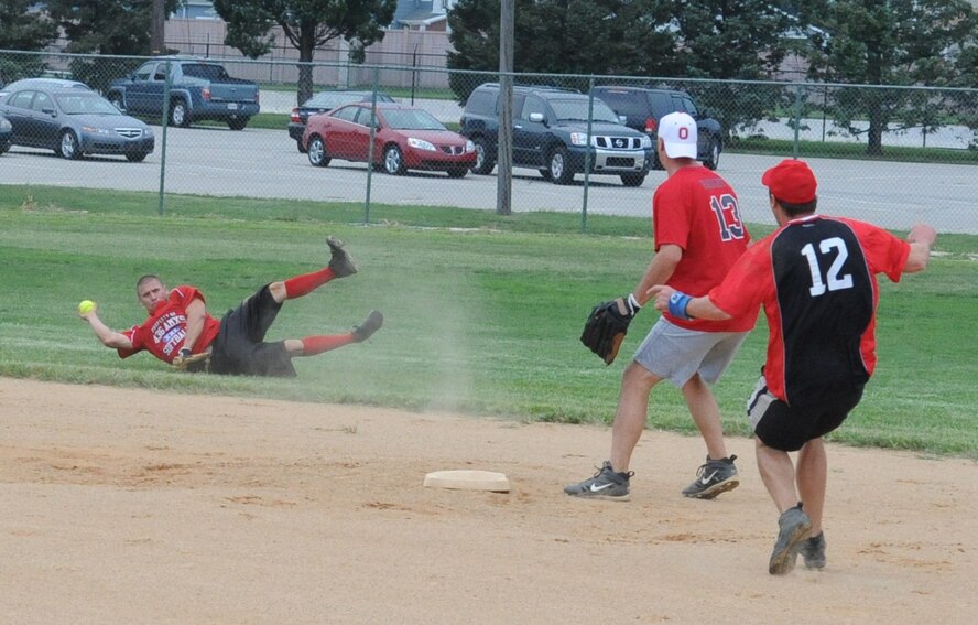 Adrian Perez, 436th Aircraft Maintenance Squadron, makes a diving catch and throw to second base during the intramural softball championship game August 19.  436 AMXS defeated the 436th Civil Engineer Squadron 4-3.  (U.S. Air Force photo by Staff Sgt. Chad Padgett)