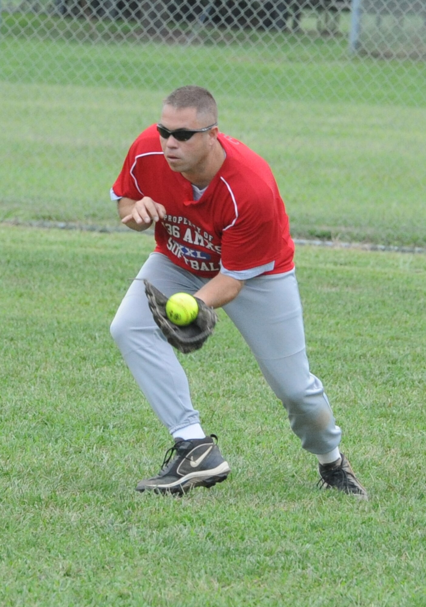 Robert Cote, 436th Aircraft Maintenance Squadron outfielder, makes a running catch against the 436th Civil Engineer Squadron during the intramural softball championship game August 19.  436 AMXS defeated 436 CES A 4-3.  (U.S. Air Force photo by Staff Sgt. Chad Padgett) 