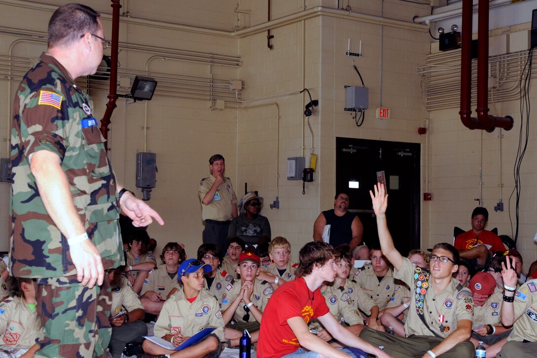 A Boy Scout asks a question during an informational briefing conducted by a member of the Civil Air Patrol while at the 2011 Selfridge Air Show and Open House at Selfridge Air National Guard Base, Mich., Aug 20, 2011. Boy Scouts from around the Detroit region were able to camp at the base for two nights during the show, work on their aviation merit badge and meet with cadets from the U.S. Air Force Academy. The Scouts also provided a variety of volunteer assistance to show organizers, such as helping to pass out wristbands to show visitors. About 200 Scouts participated in the event, with more than 180 completing the requirements for their aviation merit badge. (USAF photo by TSgt. David Kujawa)