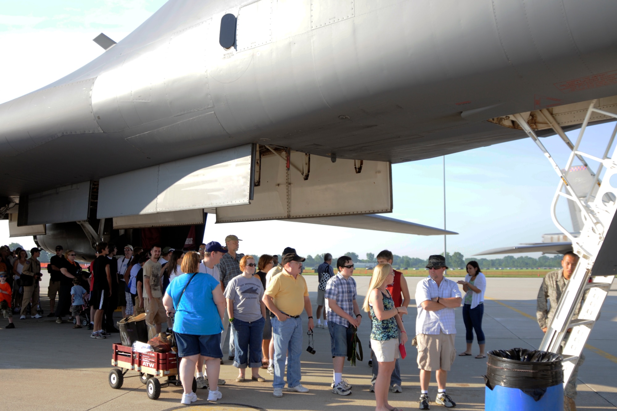 Visitors to the 2011 Selfridge Air Show and Open House stand under the fuselage of a B-1B Lancer, waiting their turn to enter the aircraft via a ladder at Selfridge Air National Guard Base, Aug. 20, 2011. The bomber, based at Dyess Air Force Base, Texas, as part of the 7th Bomb Wing, was on display for the air show. (USAF photo by TSgt. David Kujawa)